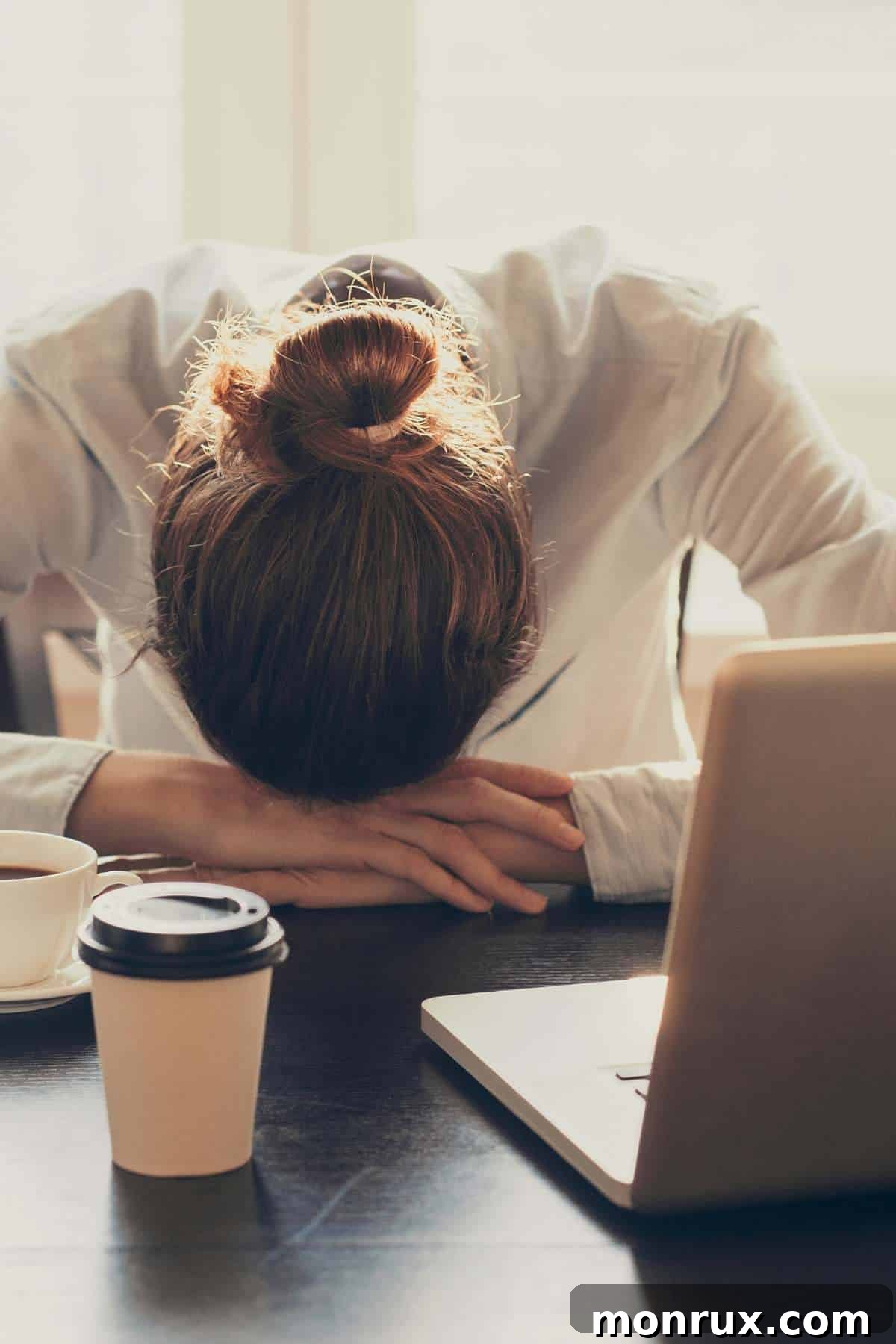 tired woman at computer, struggling with vegan diet fatigue