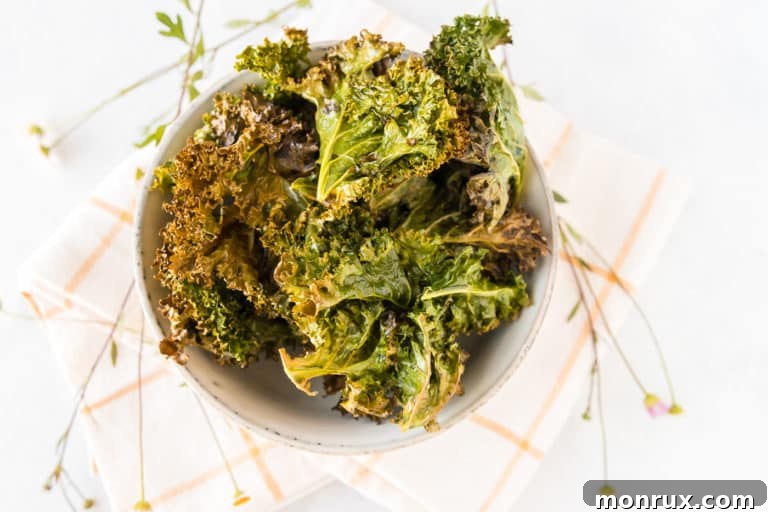 A bowl of cooked kale chips, perfectly golden and crispy.