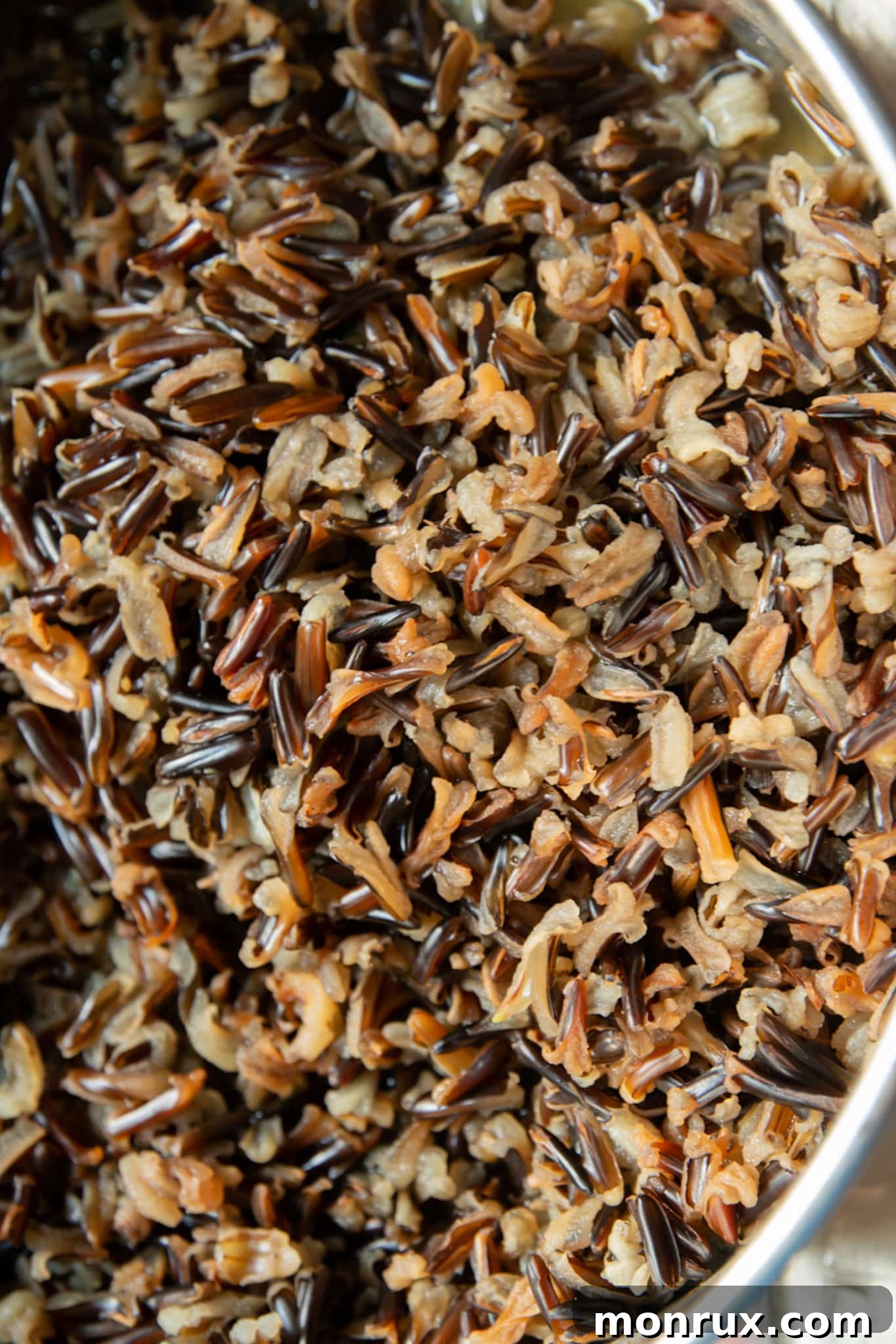 Close-up of cooked wild rice showing its distinct texture in a pot.