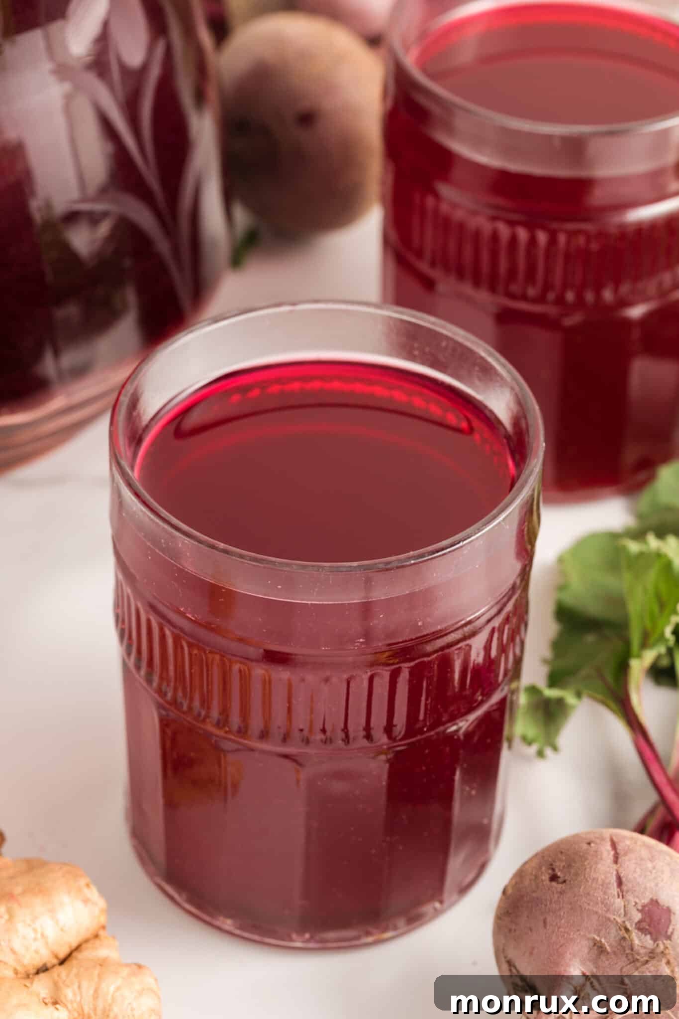 glass of homemade beet juice on table.