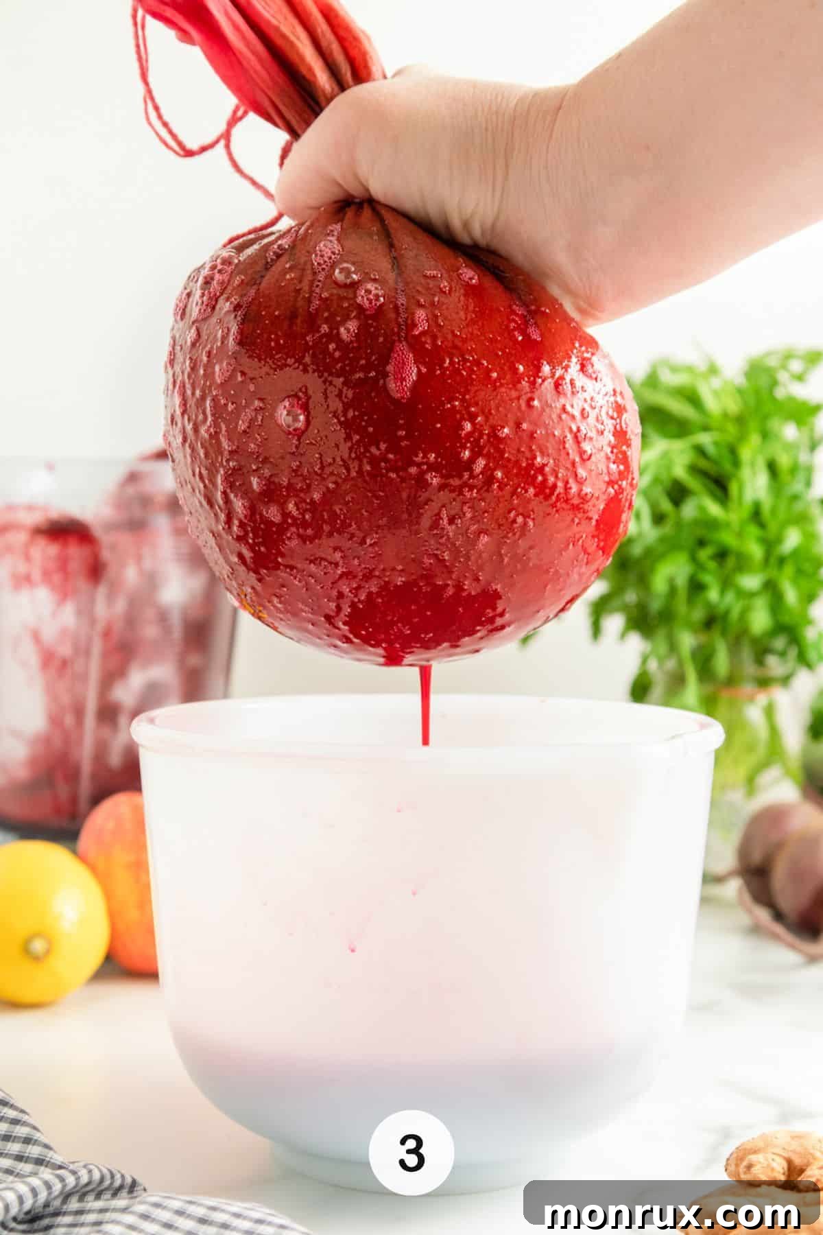 straining beet juice through nut milk bag.