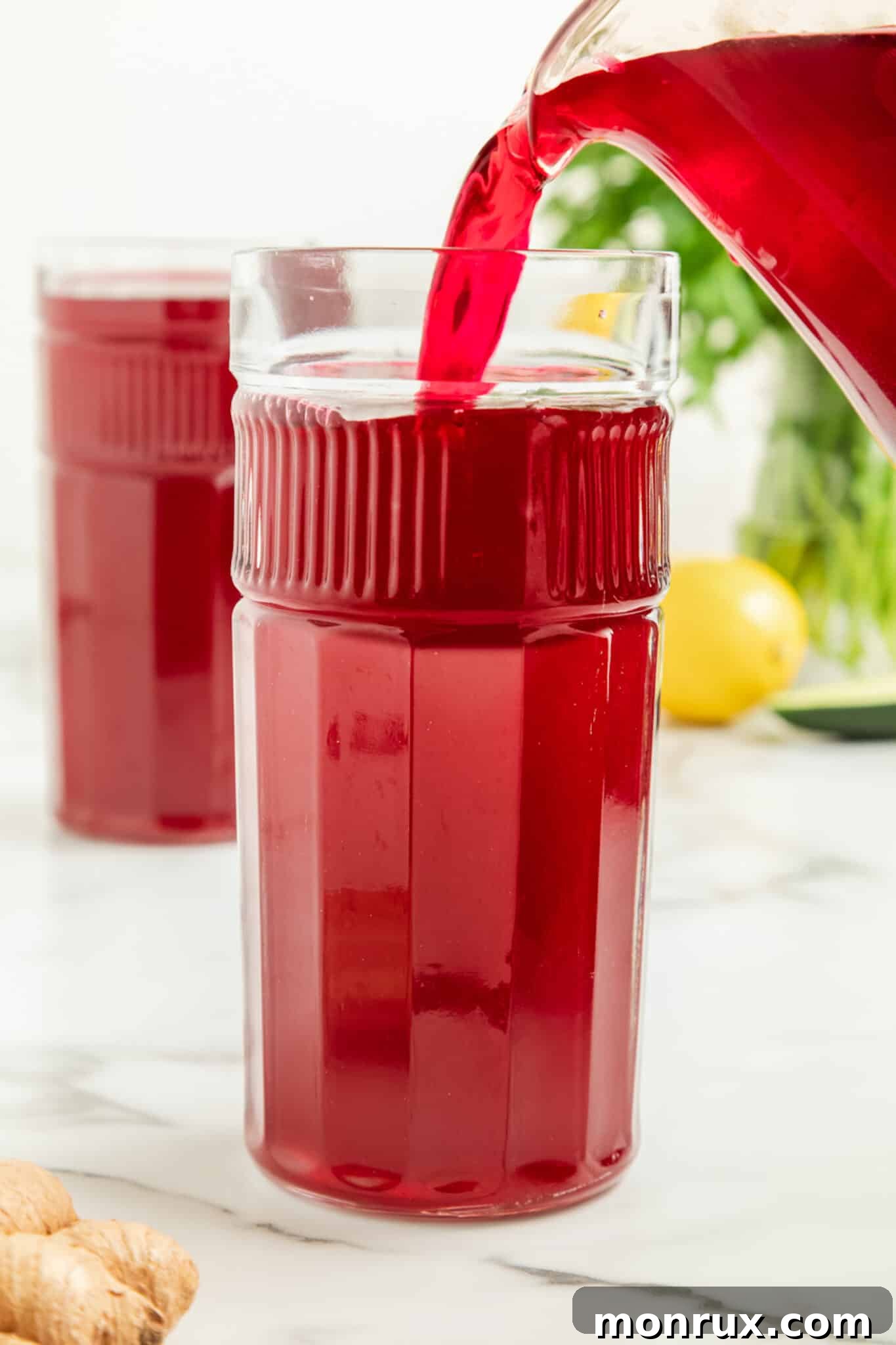pouring beet juice into glass.