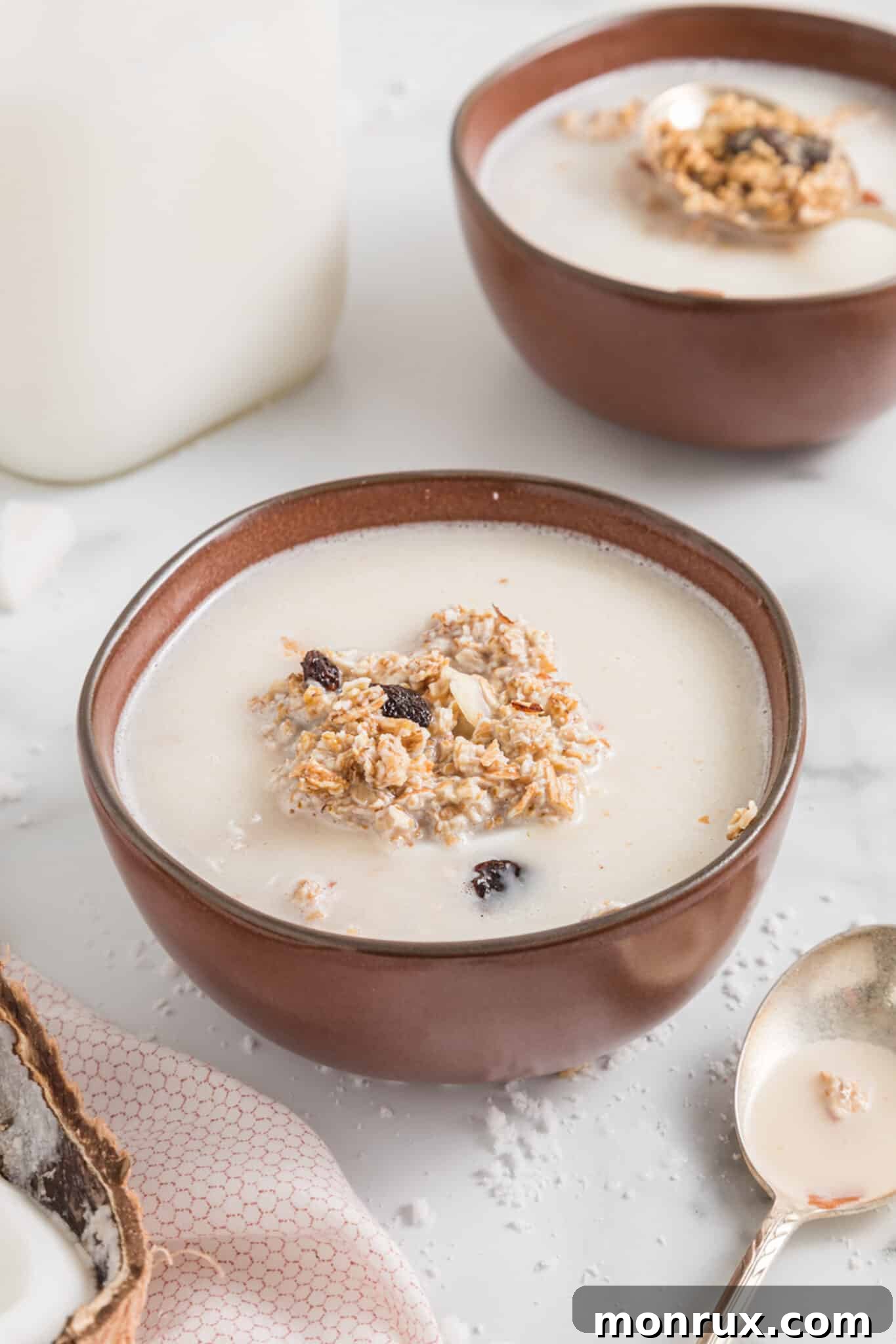 Homemade coconut milk served with granola in a bowl, ready for breakfast.