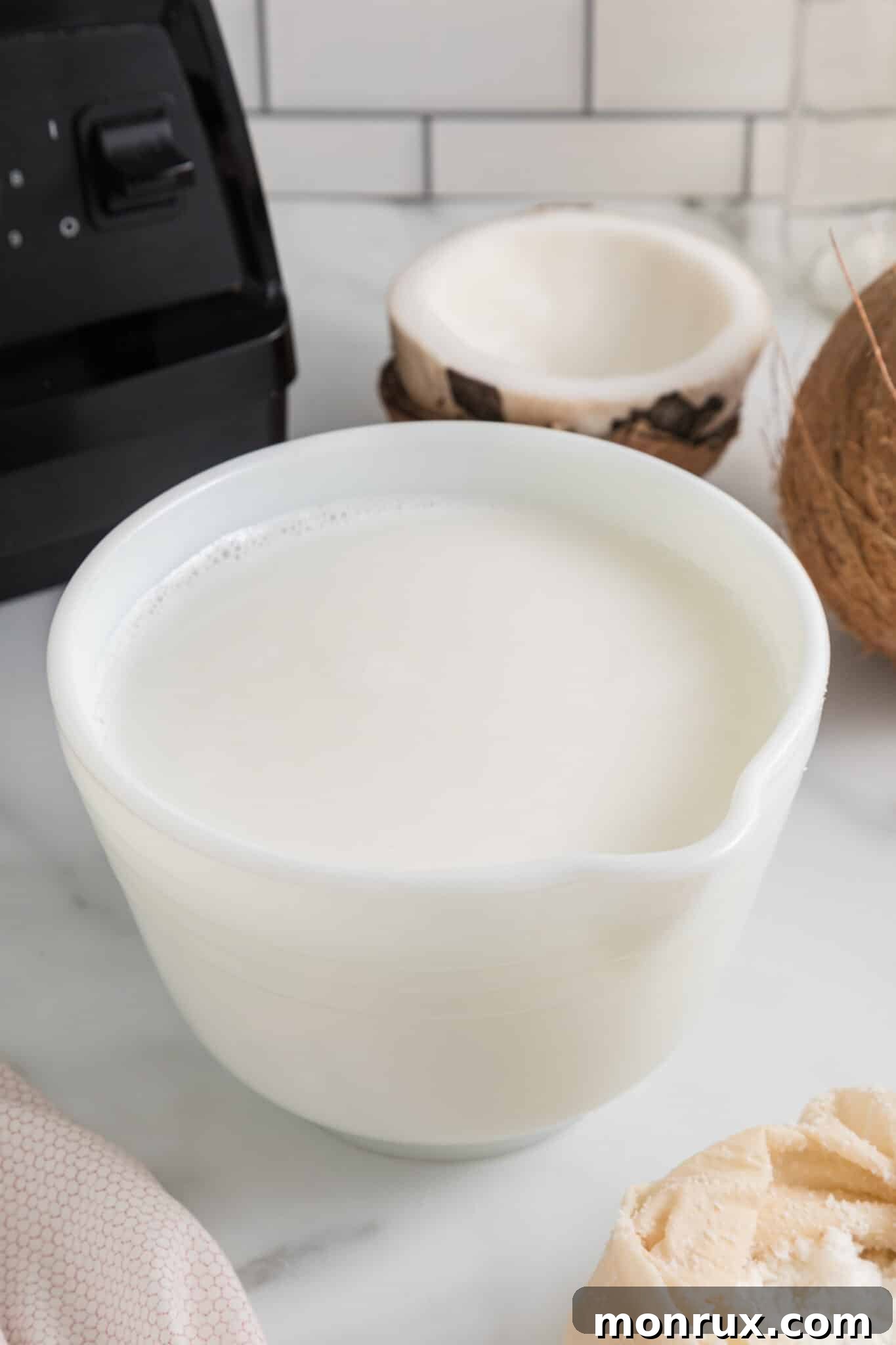 Bowl of freshly made homemade coconut milk, ready to be used.