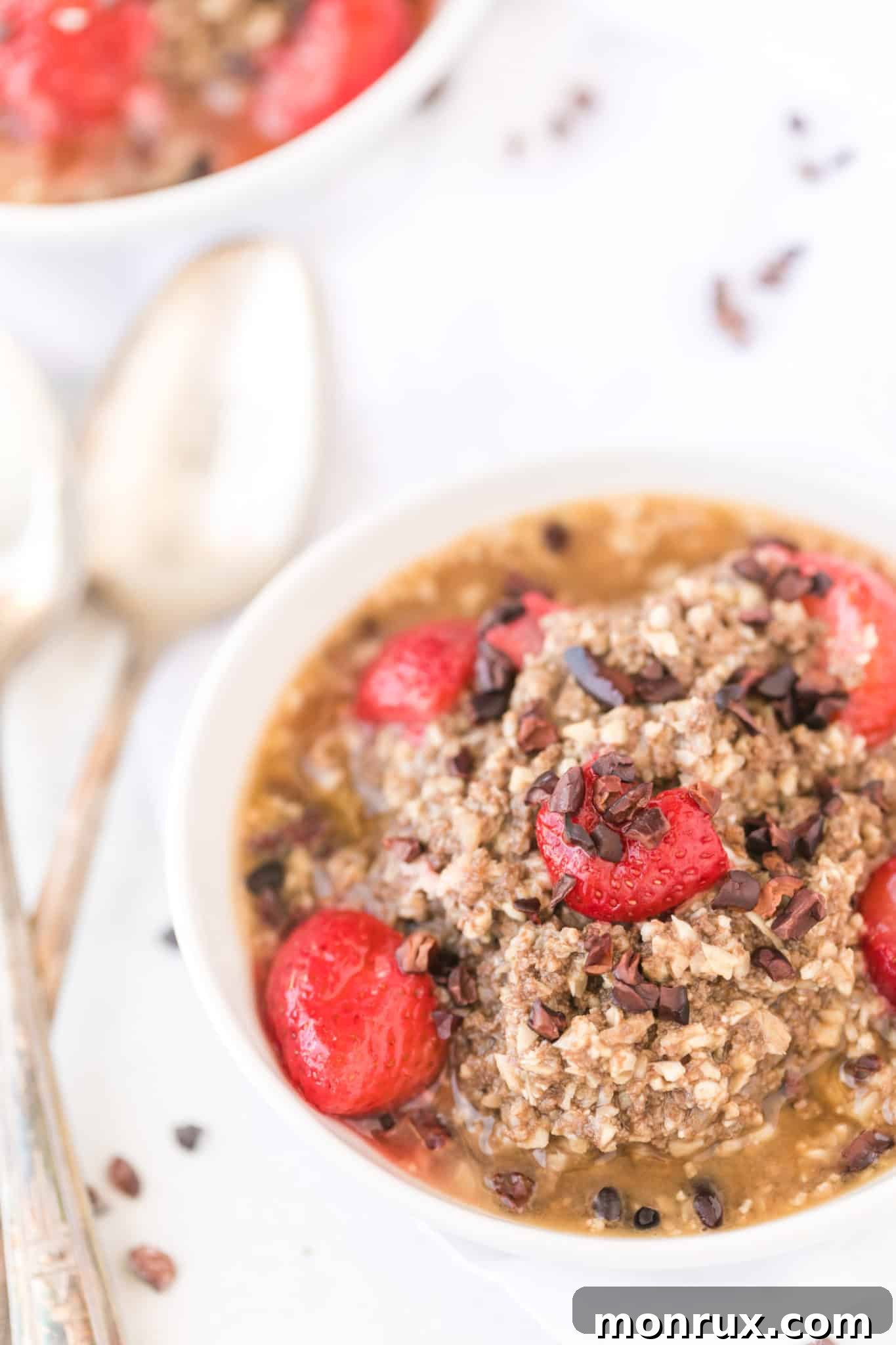 Delicious and creamy cauliflower oatmeal topped with fresh strawberries and crunchy cacao nibs, ready for a healthy breakfast.