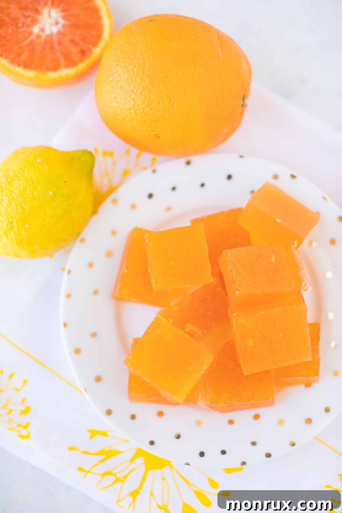 A plate featuring neatly cut slices of homemade healthy orange jello, ready to enjoy.