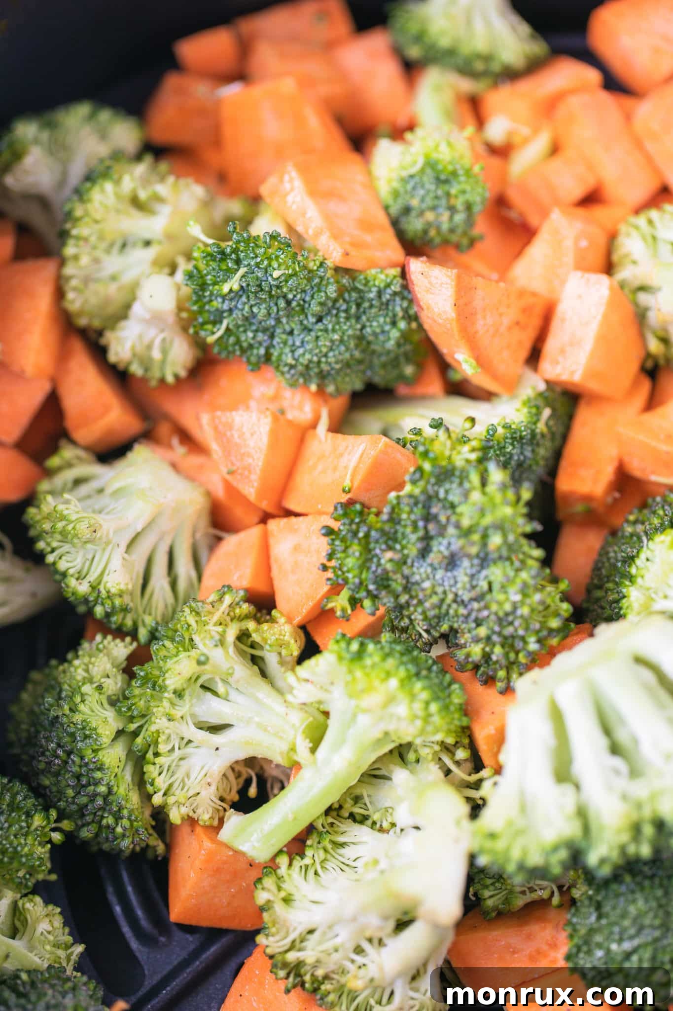 Chopped broccoli and sweet potatoes in a mixing bowl