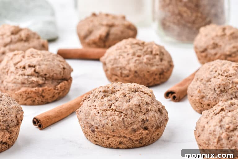 Flax muffins and cinnamon sticks beautifully arranged on a white counter, emphasizing a healthy and flavorful snack.