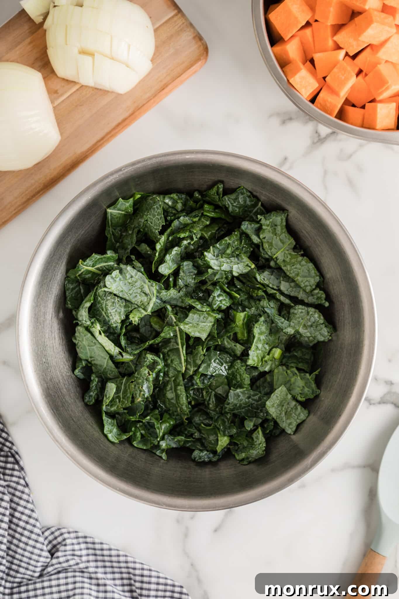 making roasted kale and sweet potato with kale in bowl.