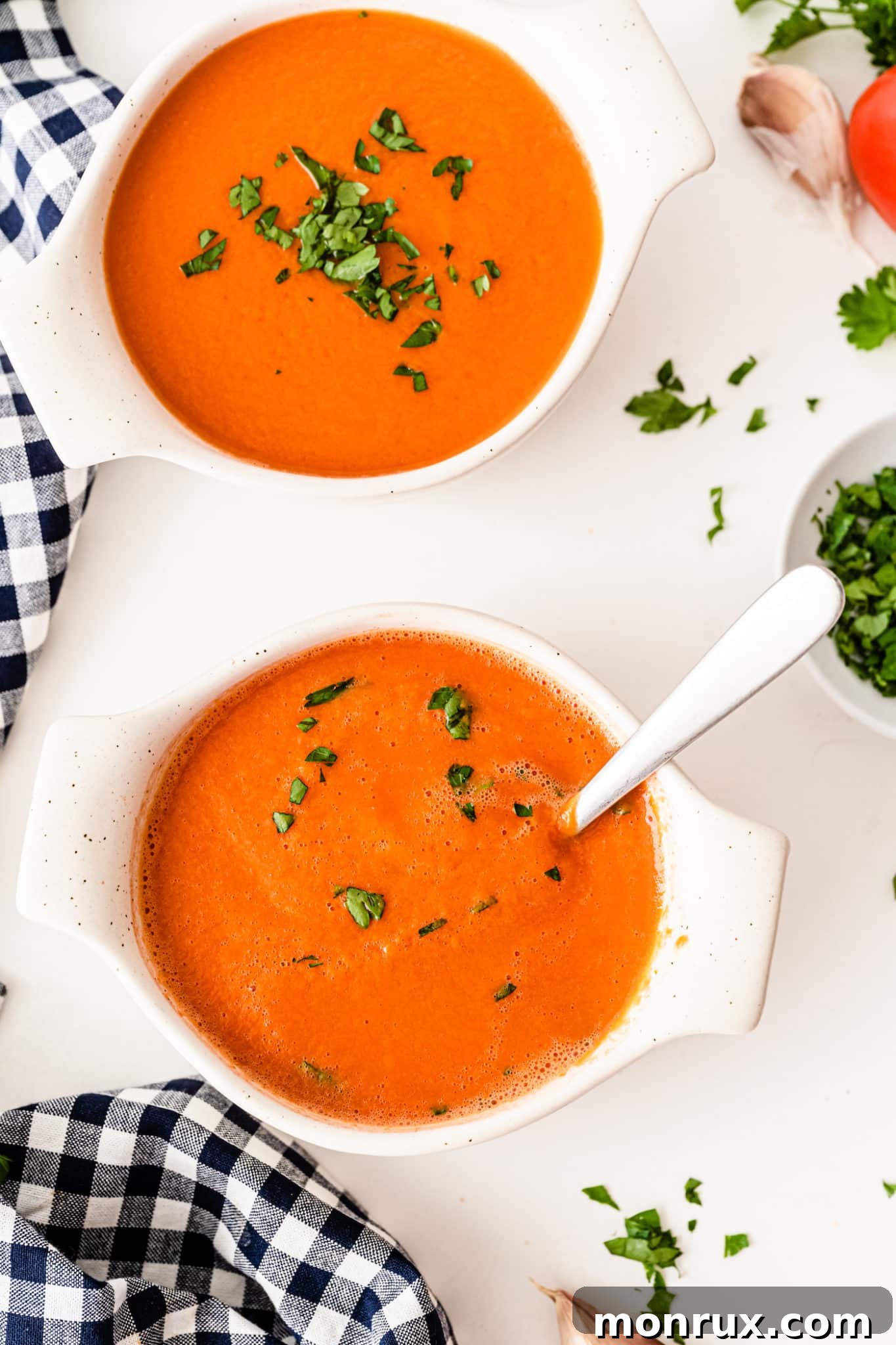 Two bowls of hot Vitamix Tomato Soup, ready to be served, with a hint of steam.