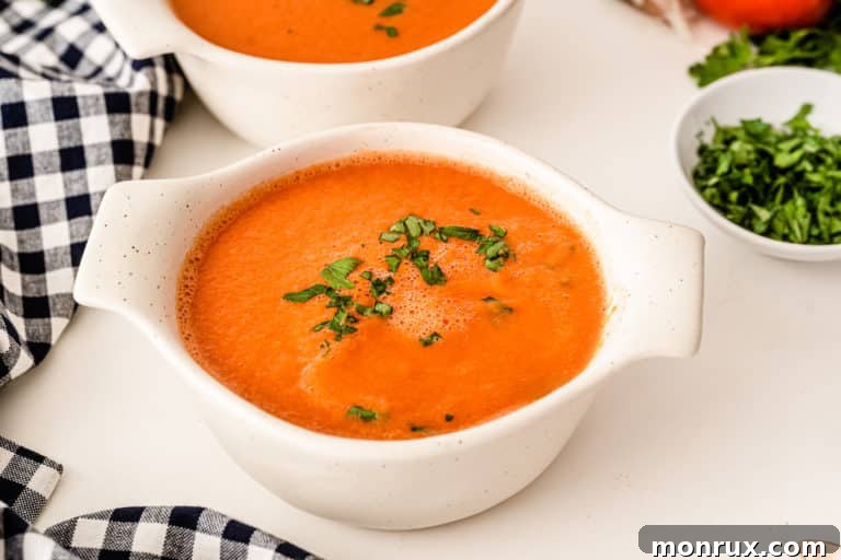 A beautiful bowl of creamy tomato soup, ready to be enjoyed.