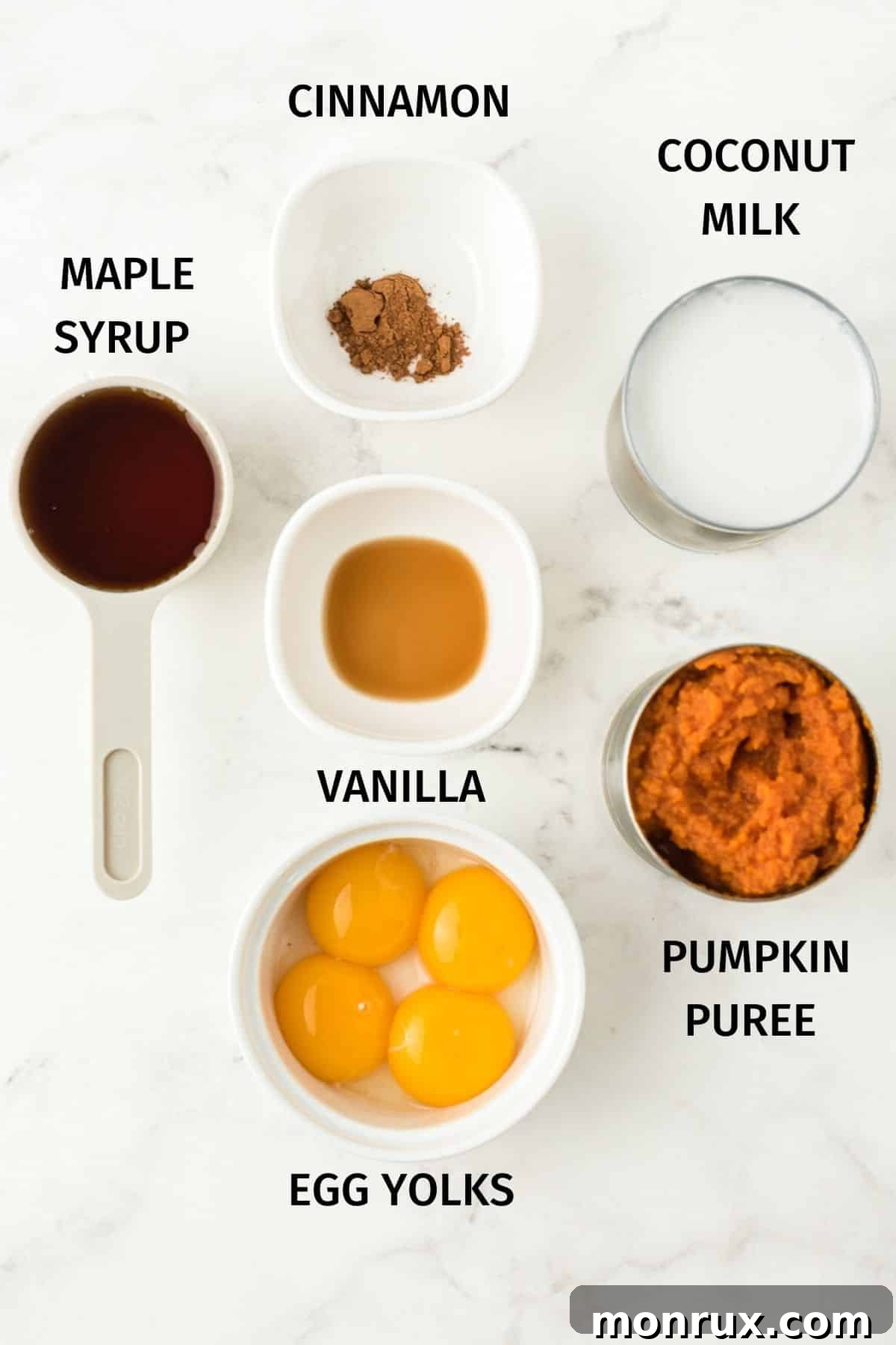 Close-up photo of all the labeled ingredients needed to make delicious dairy free pumpkin pudding, laid out on a kitchen surface.