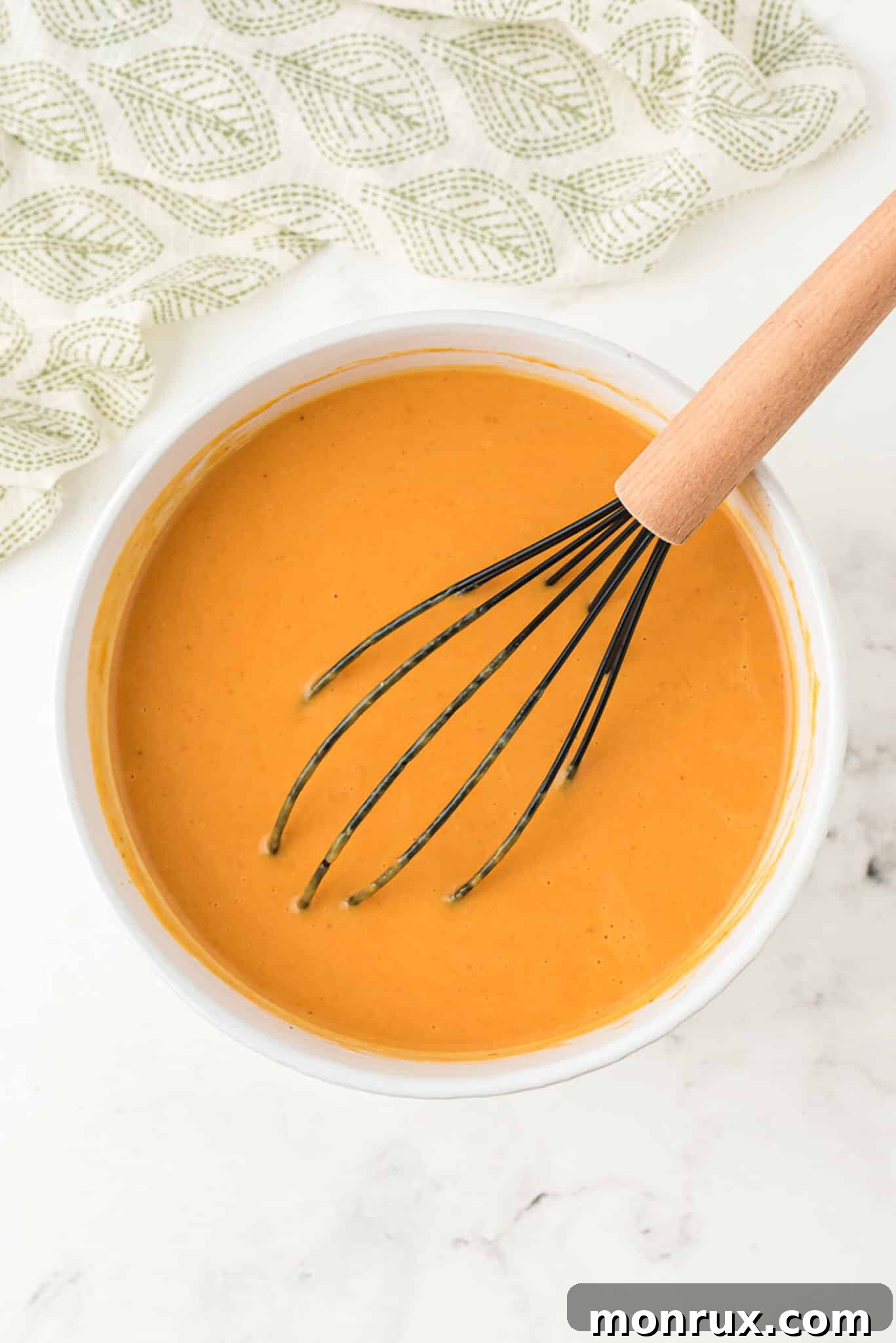 Close-up of the perfectly whisked dairy-free pumpkin pudding mixture in a bowl, smooth and lump-free.