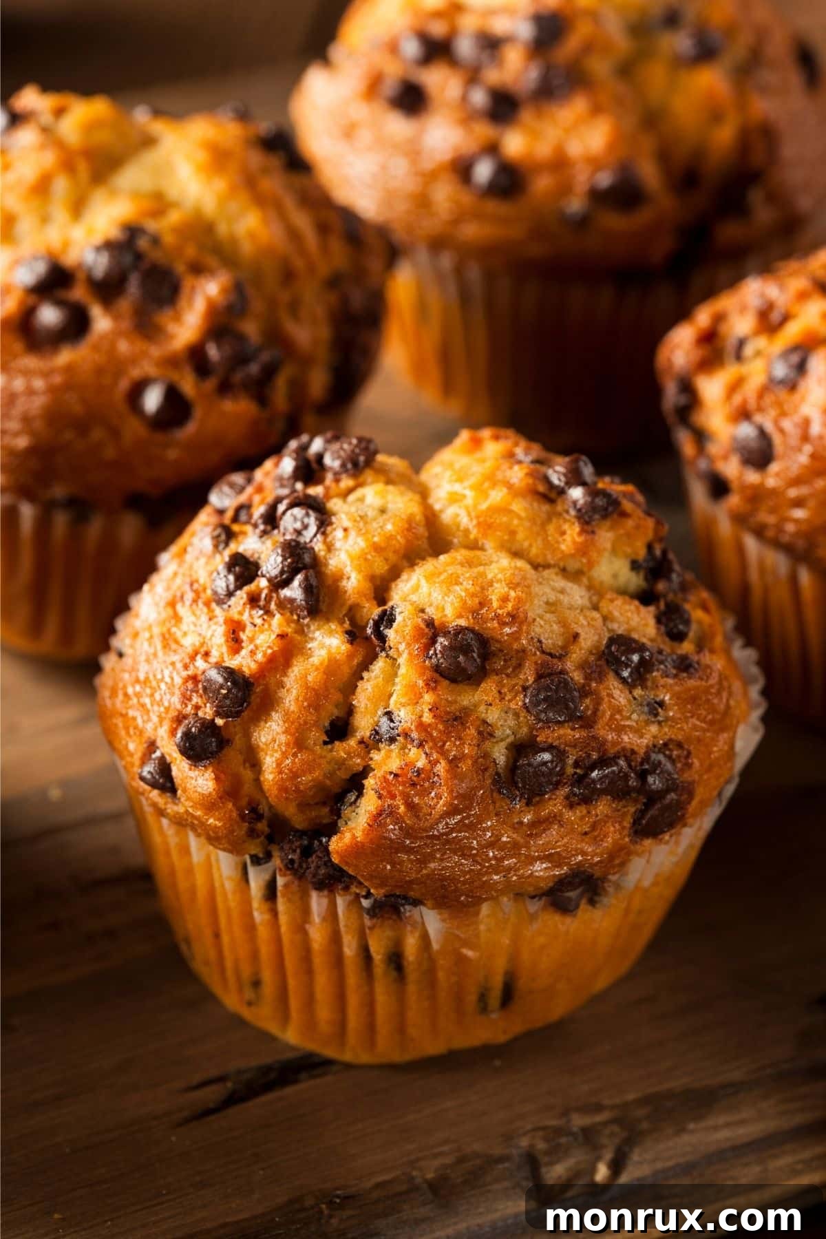 A charming group of freshly baked cassava flour chocolate chip muffins, showcasing their golden-brown tops and rich chocolatey interiors.