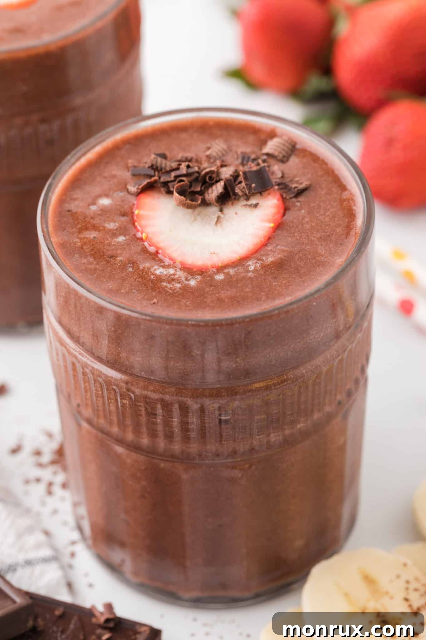 Creamy Strawberry Banana Chocolate Smoothie in a glass, topped with chocolate shavings, highlighting its rich and healthy appeal.