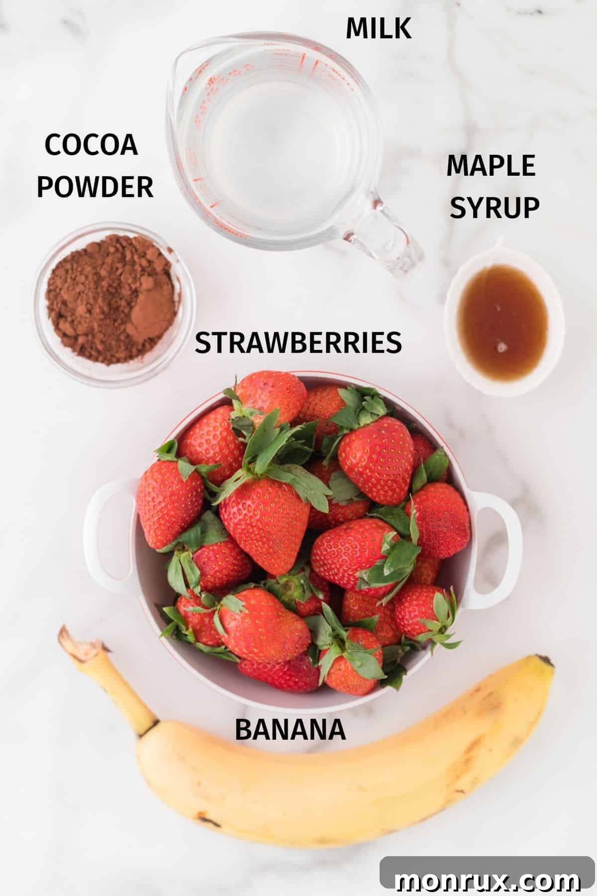 Five simple ingredients for a healthy chocolate strawberry banana smoothie: plant milk, strawberries, bananas, cocoa powder, and maple syrup.