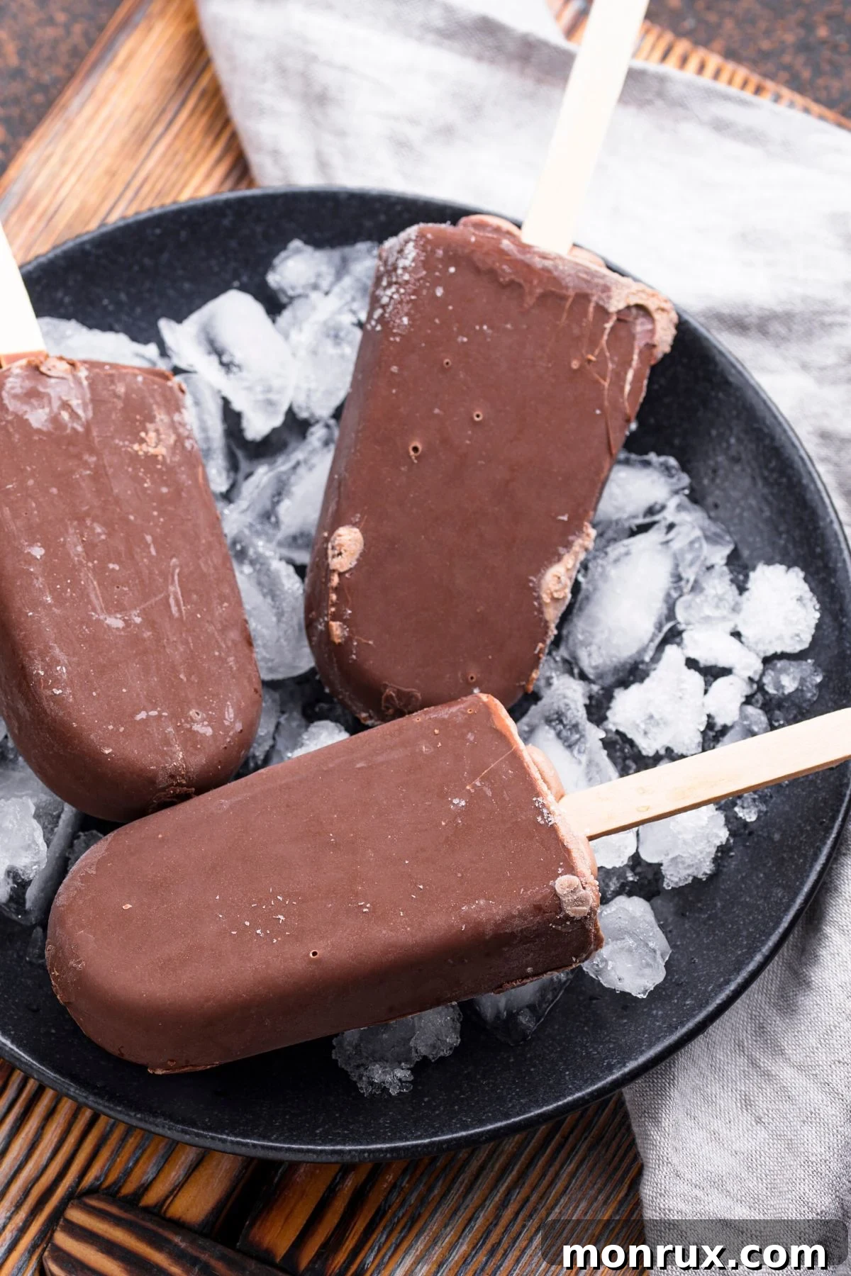 Delicious vegan fudgesicles served in a bowl with ice, ready to cool you down.