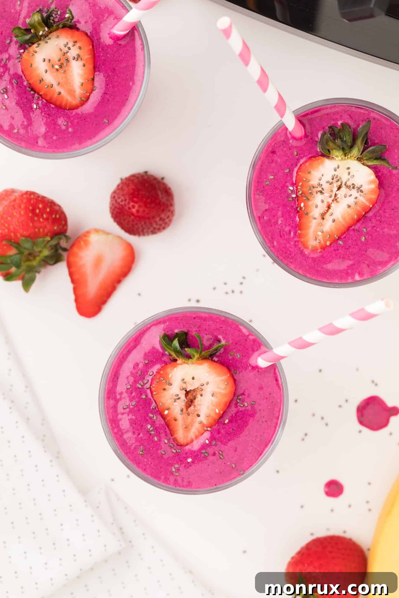 acai smoothie in glasses with straws