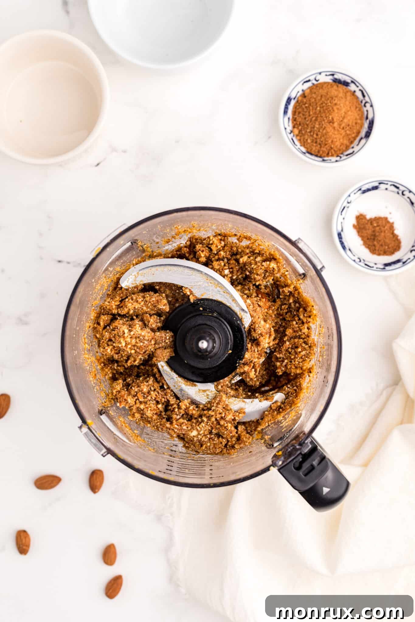 Making pumpkin protein balls in a food processor, showing the mixture being blended.