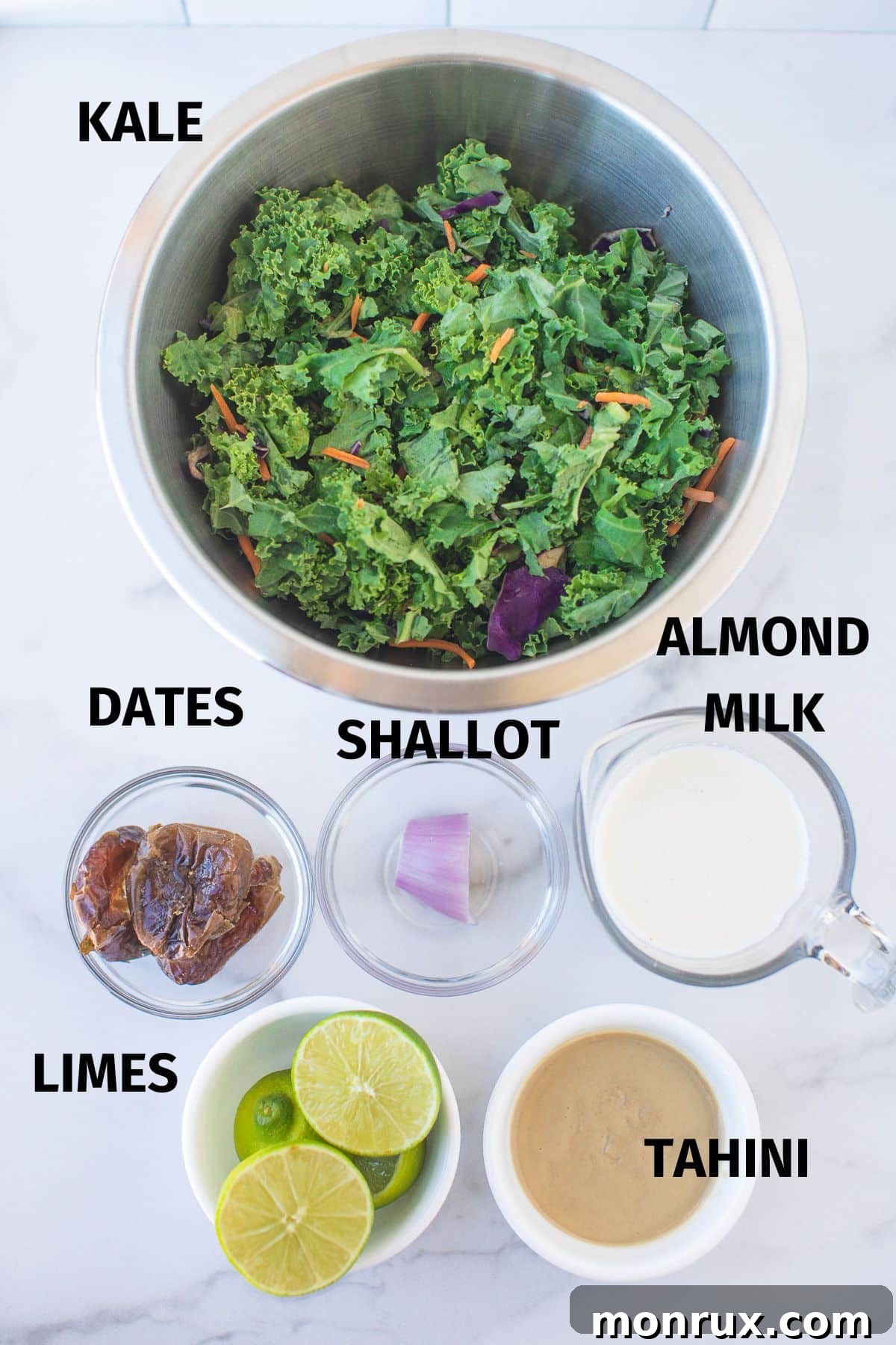 A visual display of all the key ingredients for making the creamy vegan kale salad, clearly labeled to assist the cook.