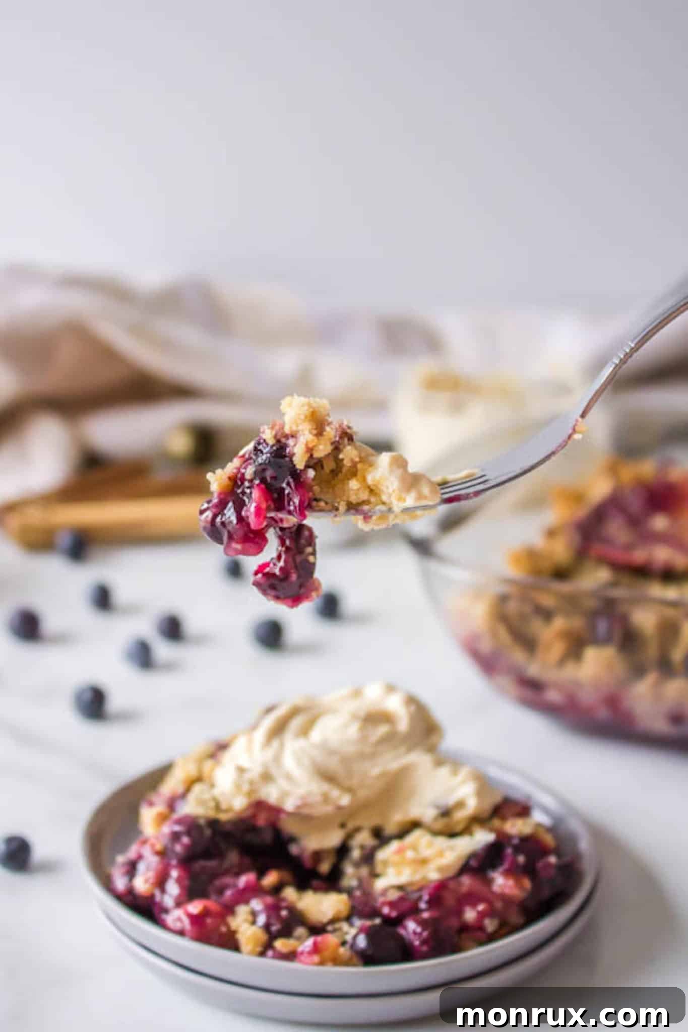 bite of blueberry dessert with whipped topping.