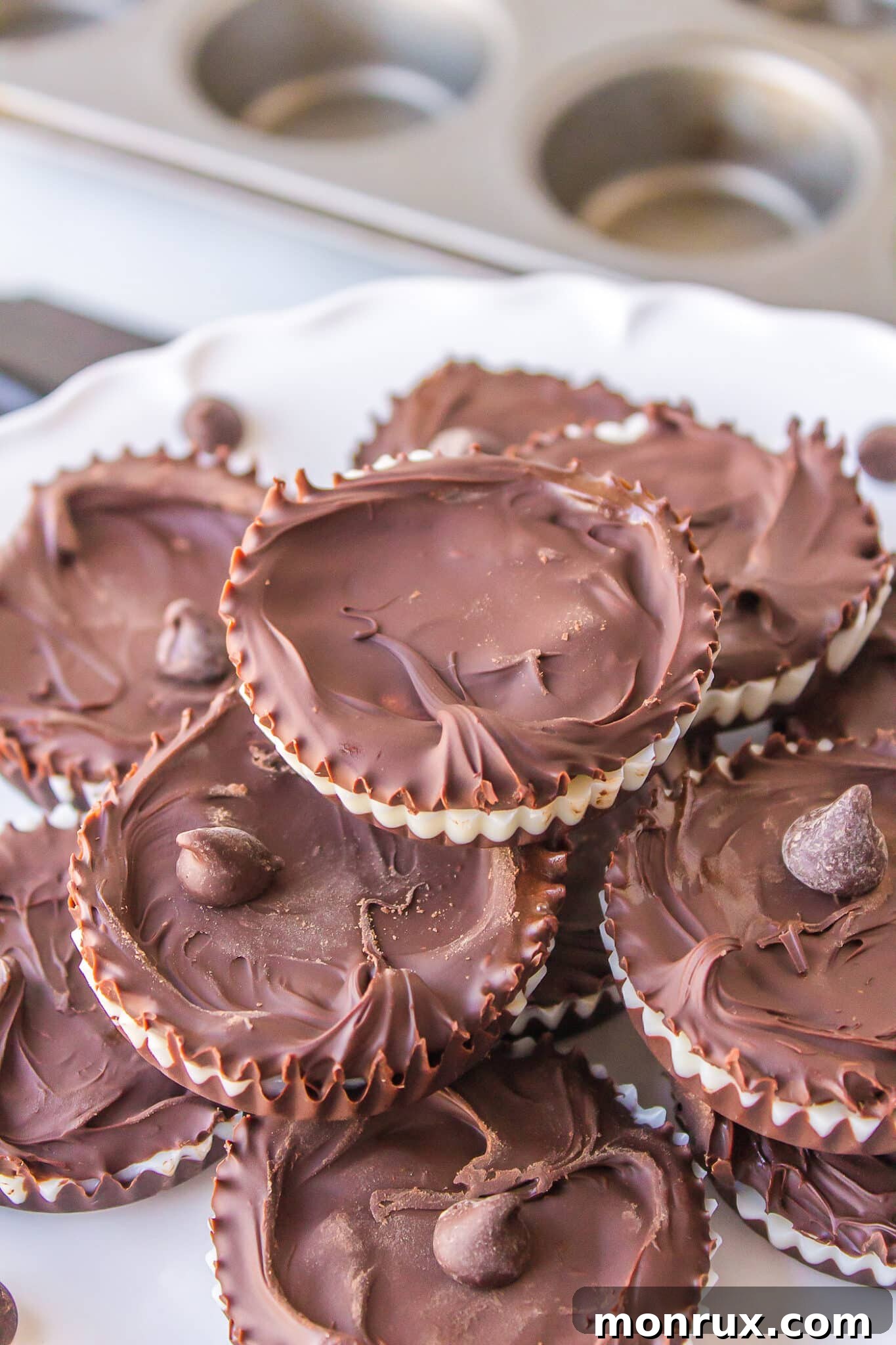 Three-ingredient homemade peppermint patty candies stacked on a plate, showcasing their inviting appearance and simple elegance.