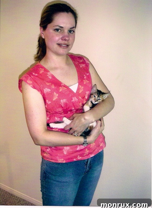 Carrie holding a young Xena kitten, a heartwarming image of their budding bond and affection.