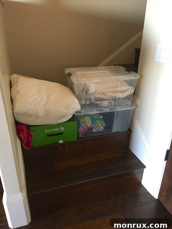 A temporary baby gate set up to safely confine kittens to a designated area downstairs.