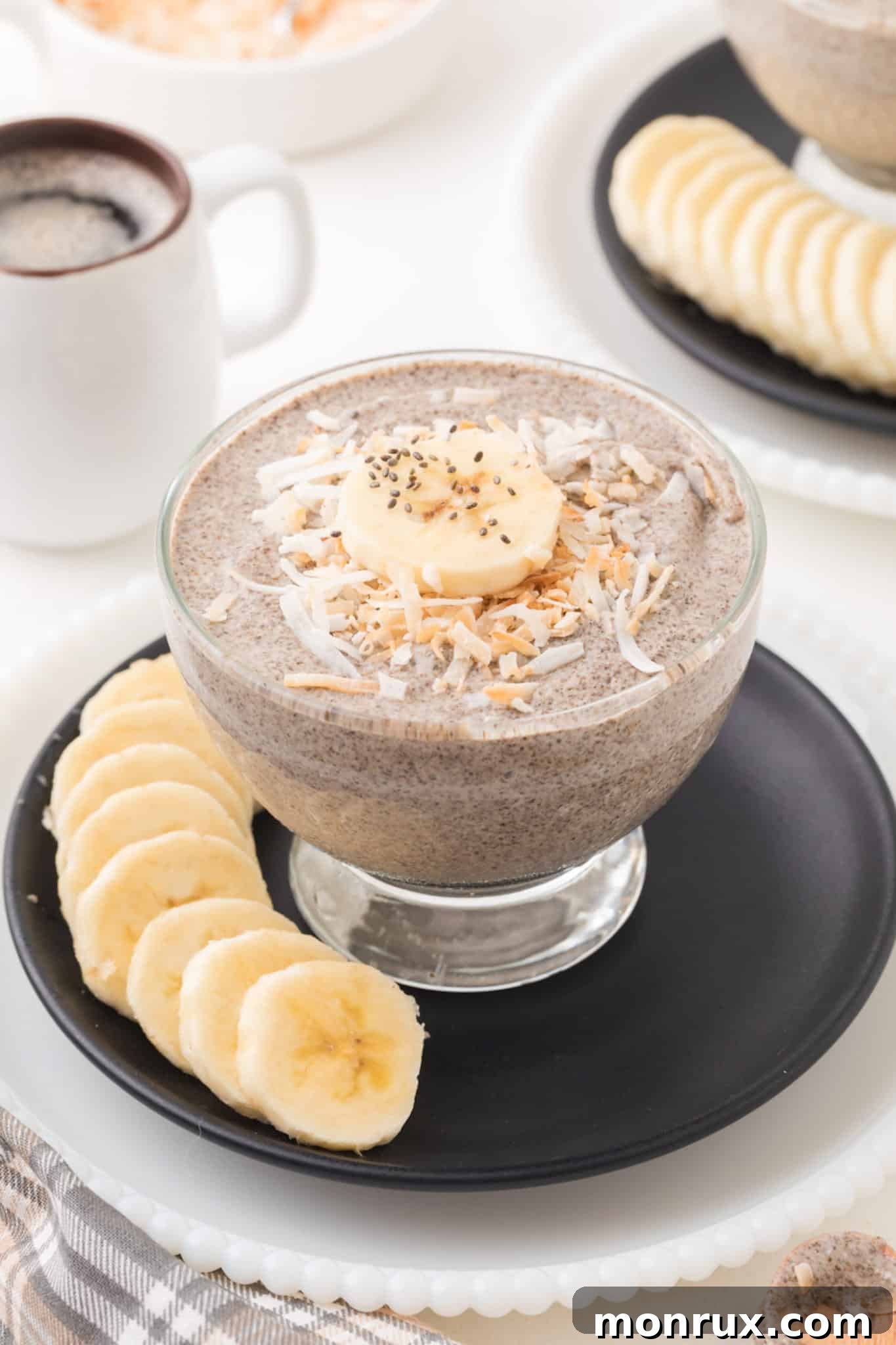 A beautifully presented bowl of creamy Whole30 Chia Pudding, topped with fresh banana slices and toasted shredded coconut, ready to be enjoyed as a healthy breakfast or snack.
