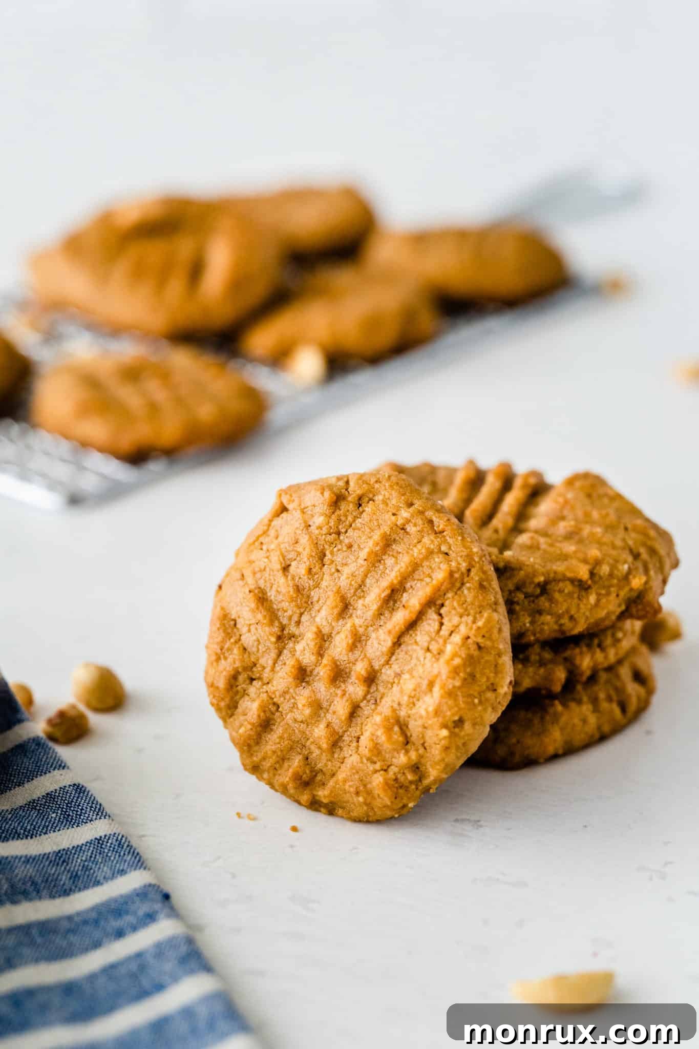 A stack of perfectly baked almond flour peanut butter cookies, showcasing their golden-brown edges and soft centers.
