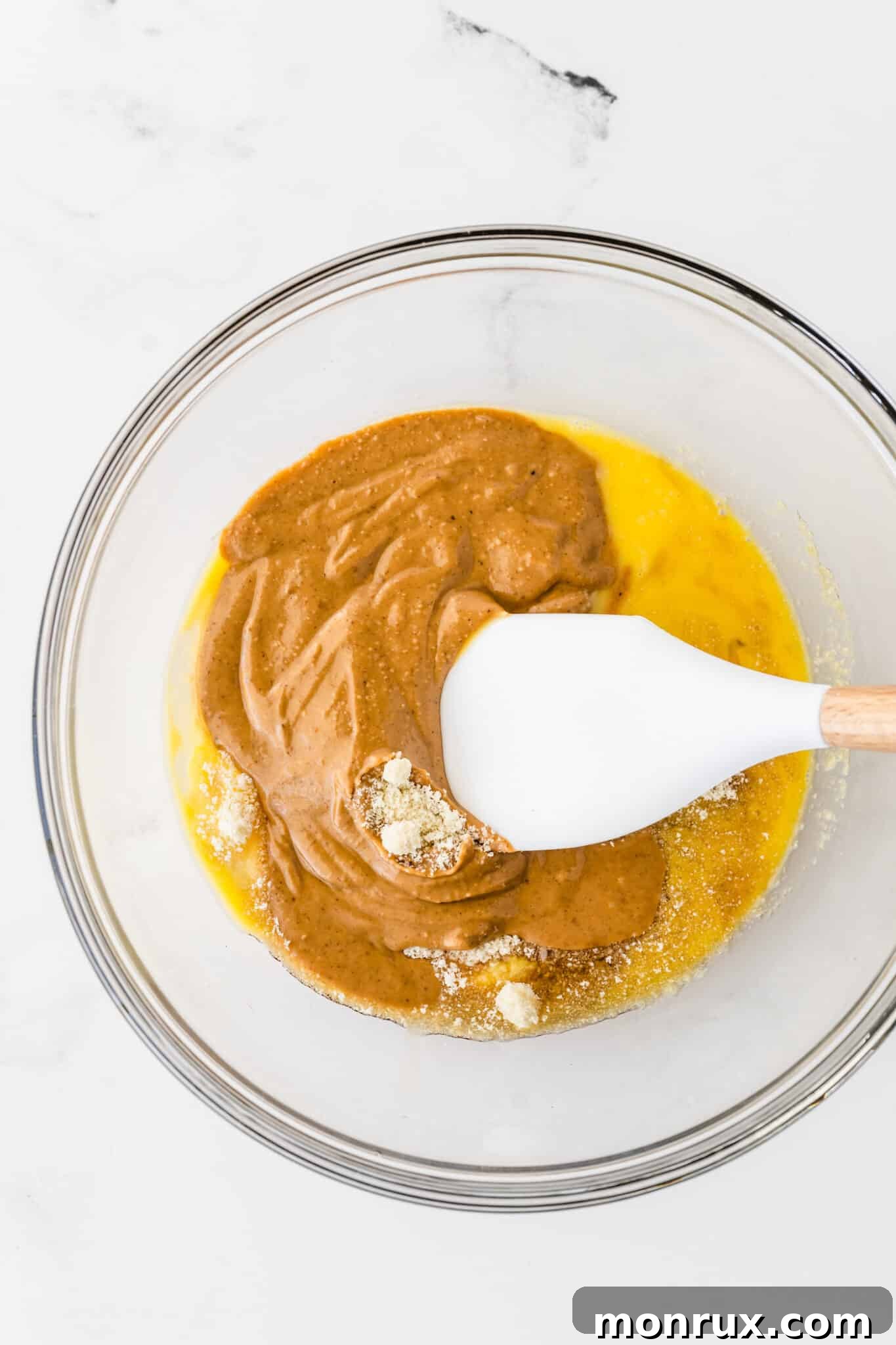 All ingredients for almond flour peanut butter cookies combined in a mixing bowl, ready to be blended.