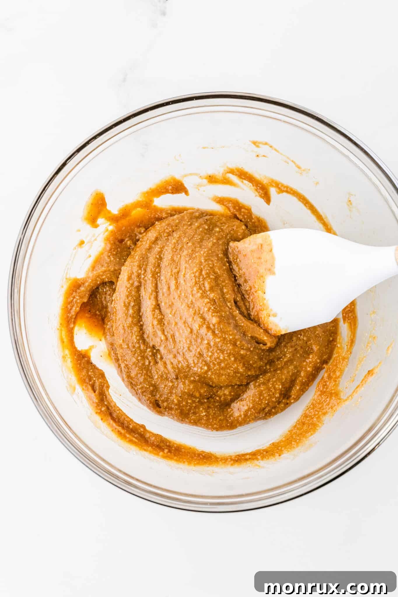 A smooth, well-blended batter for almond flour peanut butter cookies in a mixing bowl, showing the perfect consistency.