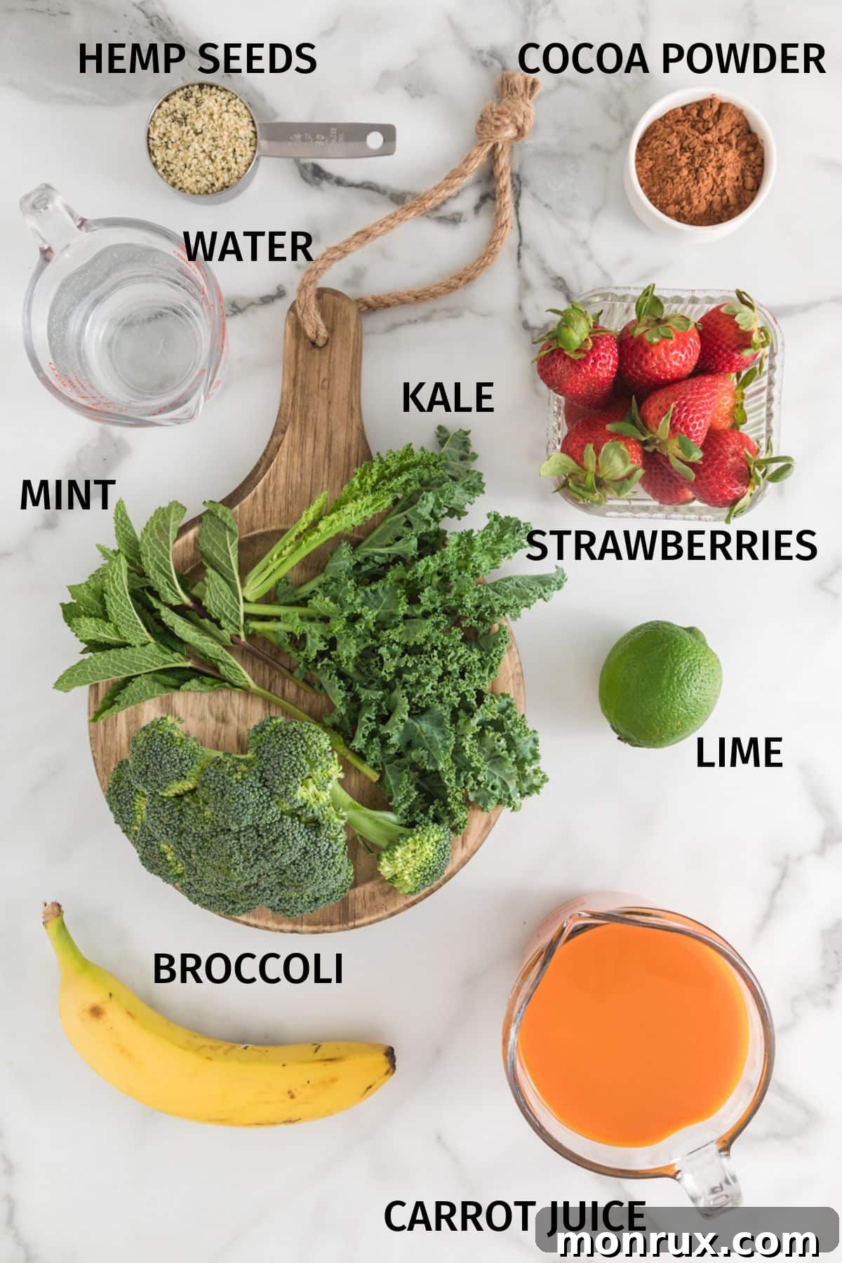 A vibrant display of ingredients arranged on a white surface, ready to be blended into a cancer-fighting green smoothie.