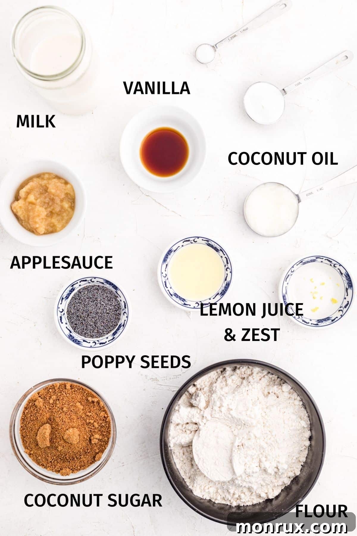 Small bowls containing all the key ingredients for gluten-free vegan lemon poppy seed muffins, arranged neatly on a white kitchen counter.