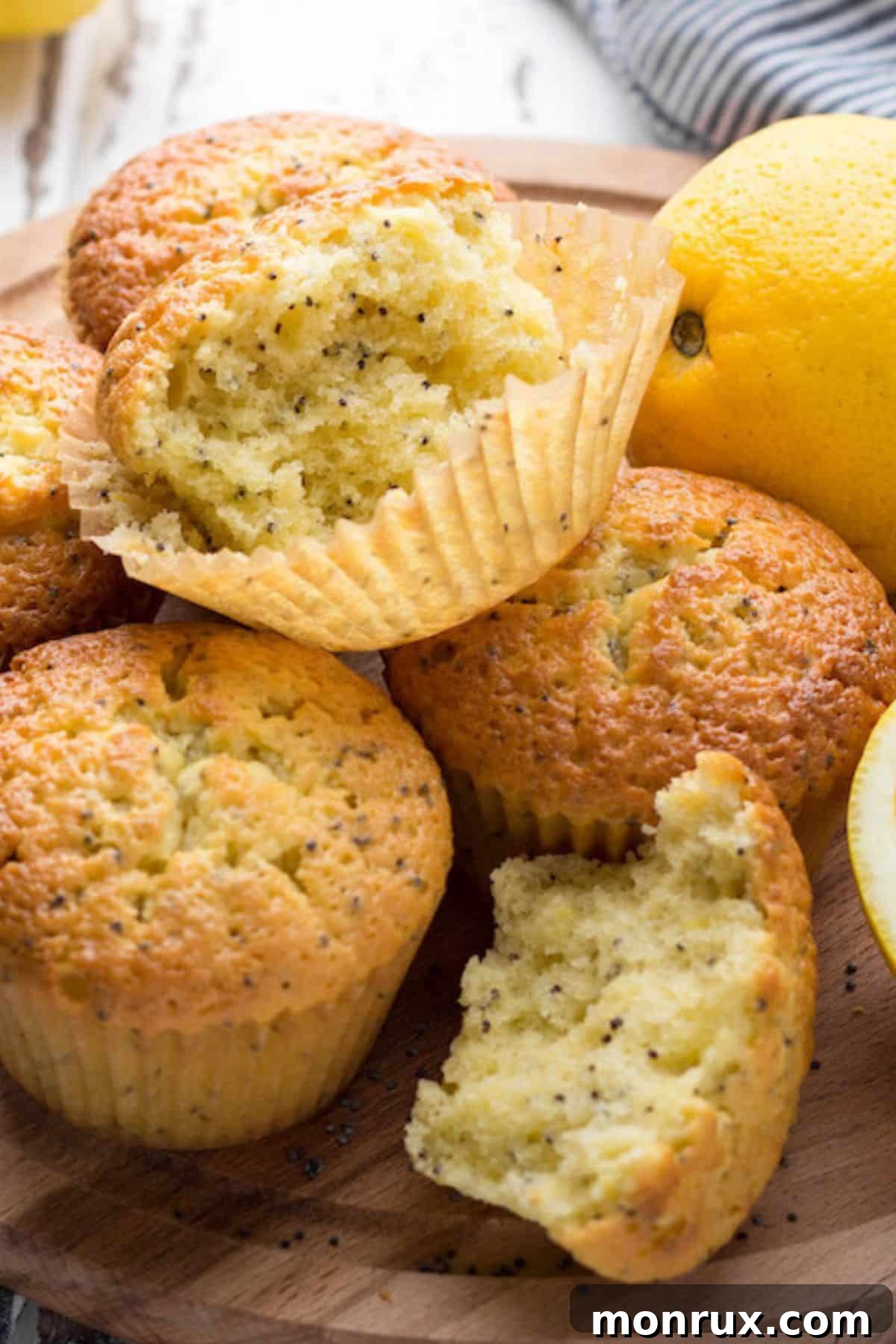 Close-up shot of baked vegan lemon poppy seed muffins on a cooling rack, showcasing their fluffy texture and golden tops.