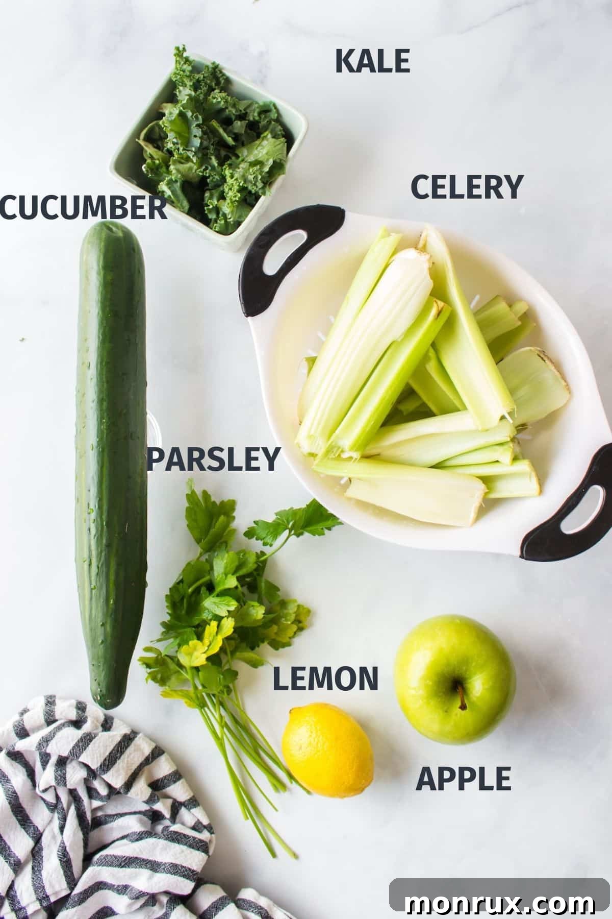 Fresh, vibrant ingredients for making a green detox juice recipe, including celery, cucumber, parsley, and leafy greens, neatly arranged.