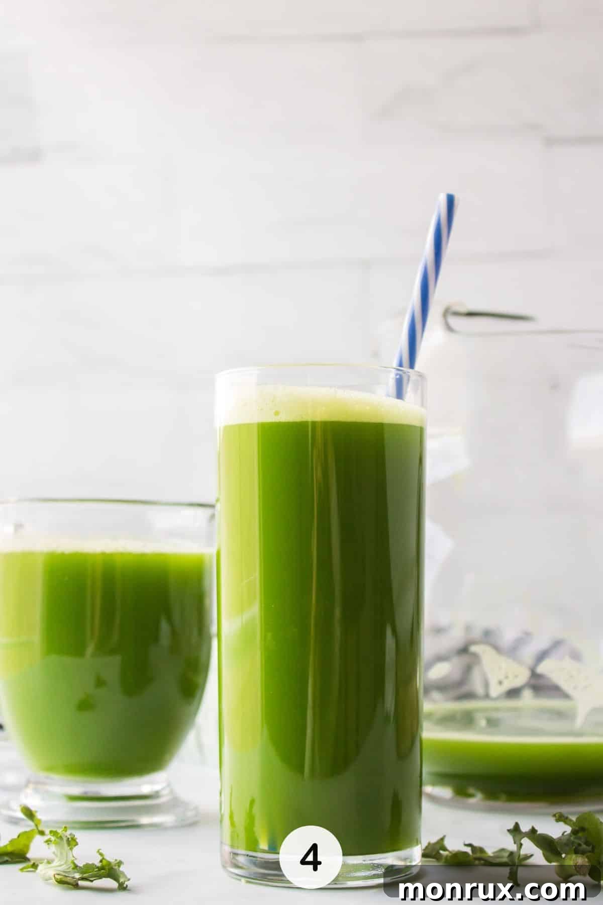 A refreshing glass of green detox juice, perfectly served with a straw and garnish, ready to be enjoyed.