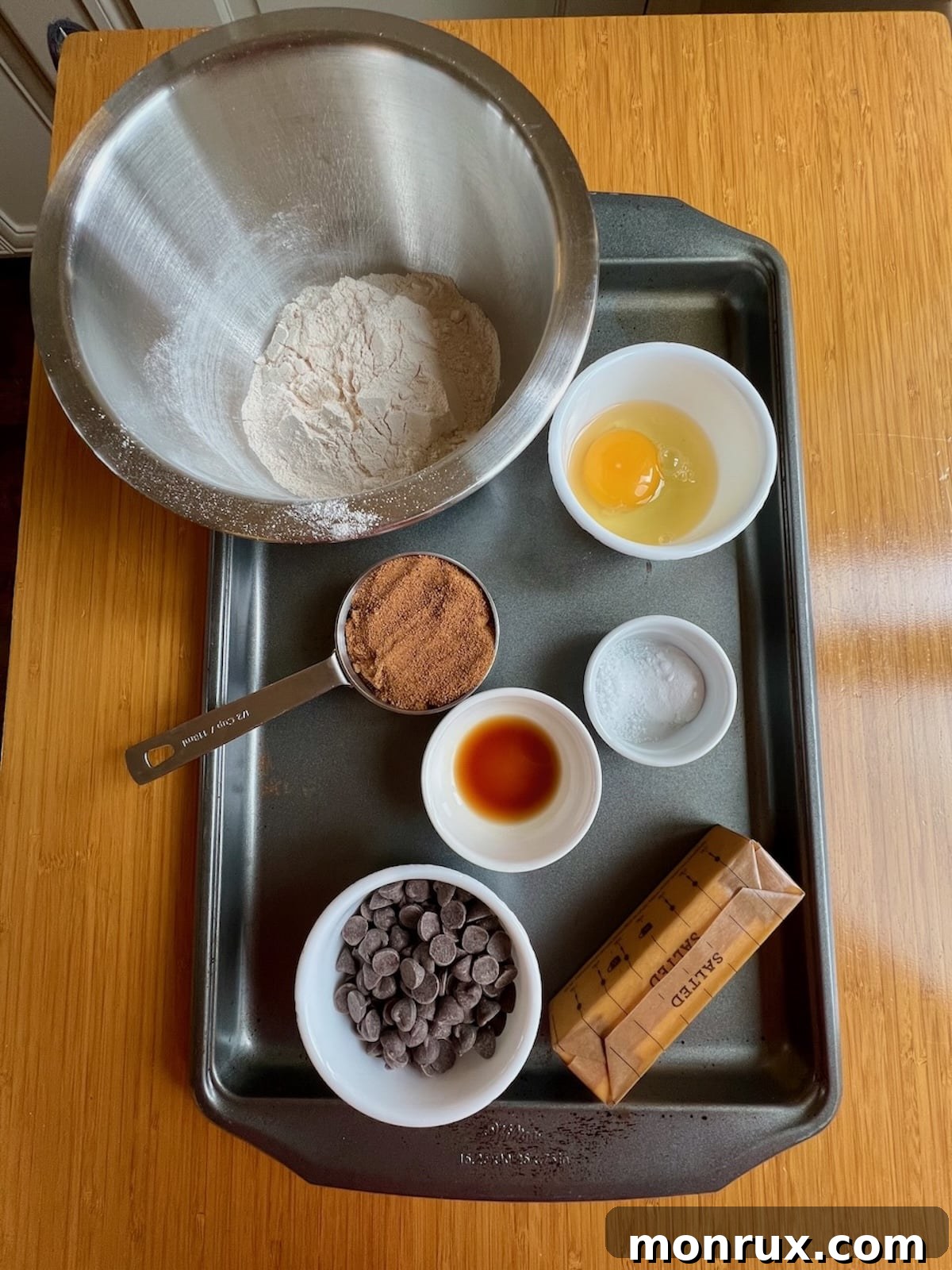 Ingredients for chocolate chip cookies laid out on a table.