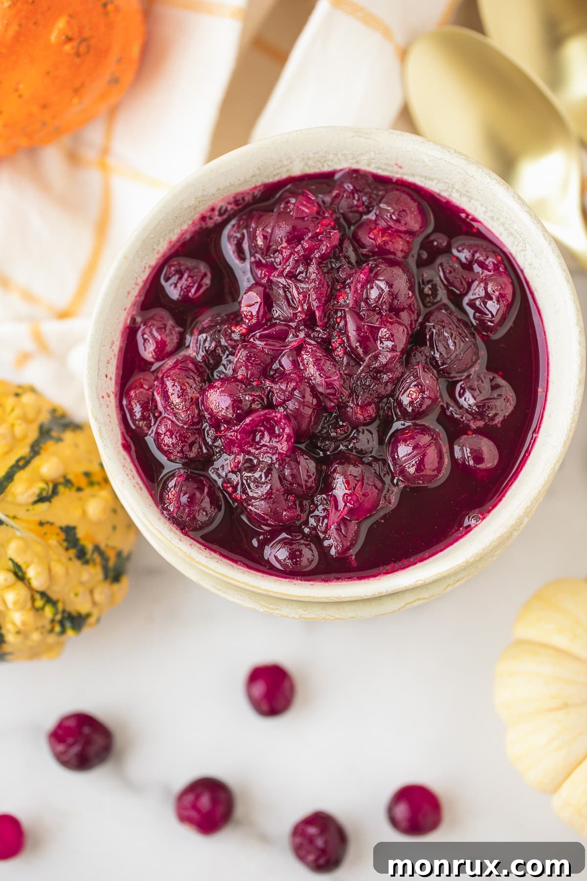 Vibrant Instant Pot Cranberry Sauce in a beautiful serving bowl, garnished with fresh cranberries and orange zest.