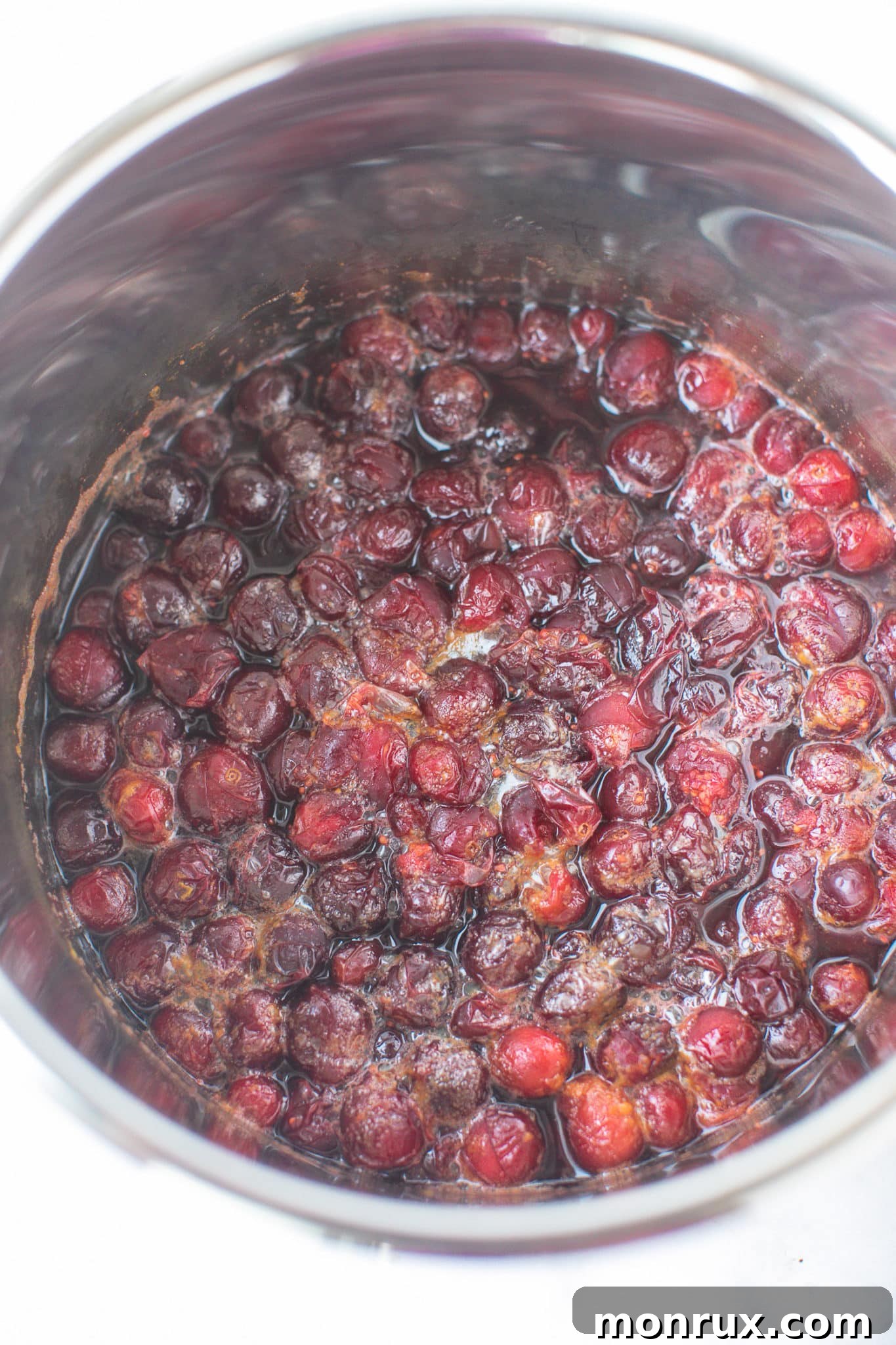Freshly cooked cranberry relish, still warm and slightly liquid, resting in the Instant Pot after pressure release.