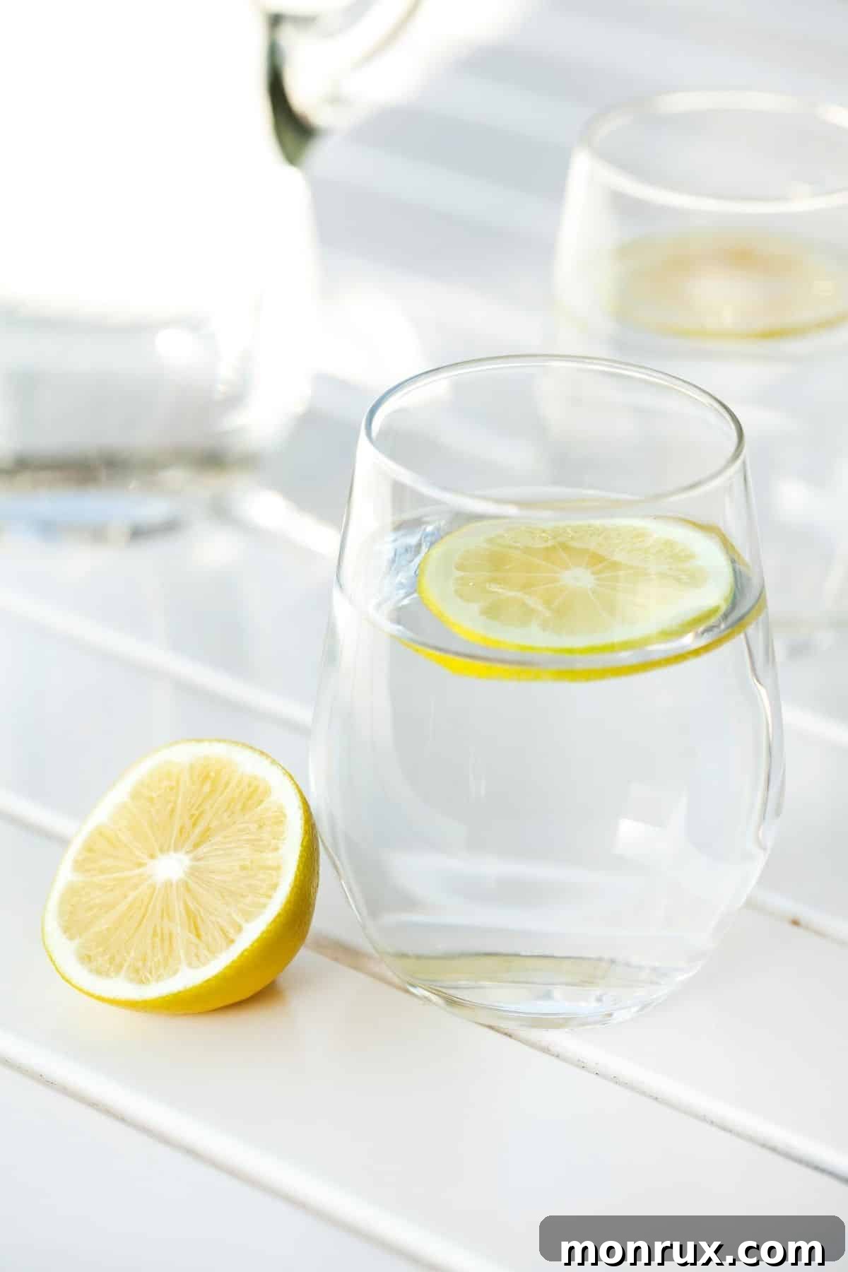 A refreshing glass of water garnished with fresh lemon slices, symbolizing hydration and healthy choices.