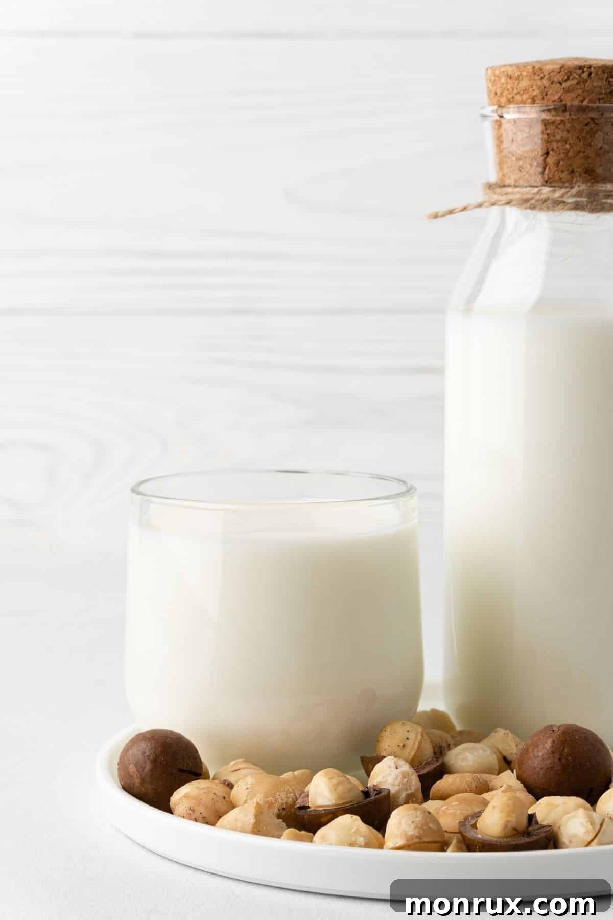 A selection of diverse nut milks in bottles arranged artfully on a wooden table, emphasizing healthy dairy alternatives.