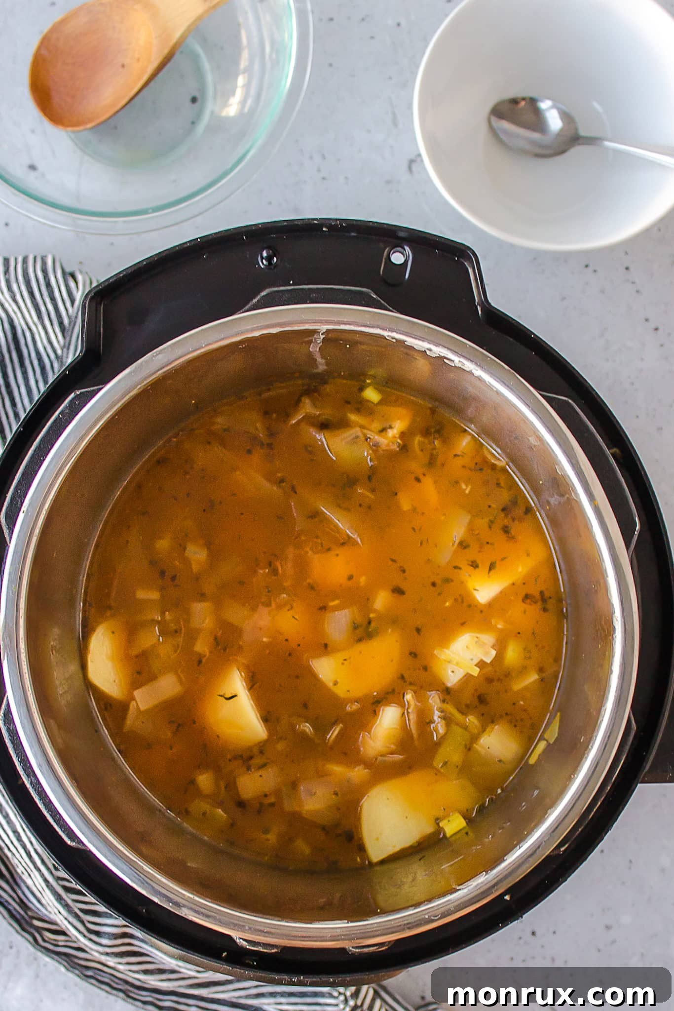 Cooked potatoes and leeks in the Instant Pot after pressure cooking, ready for blending.