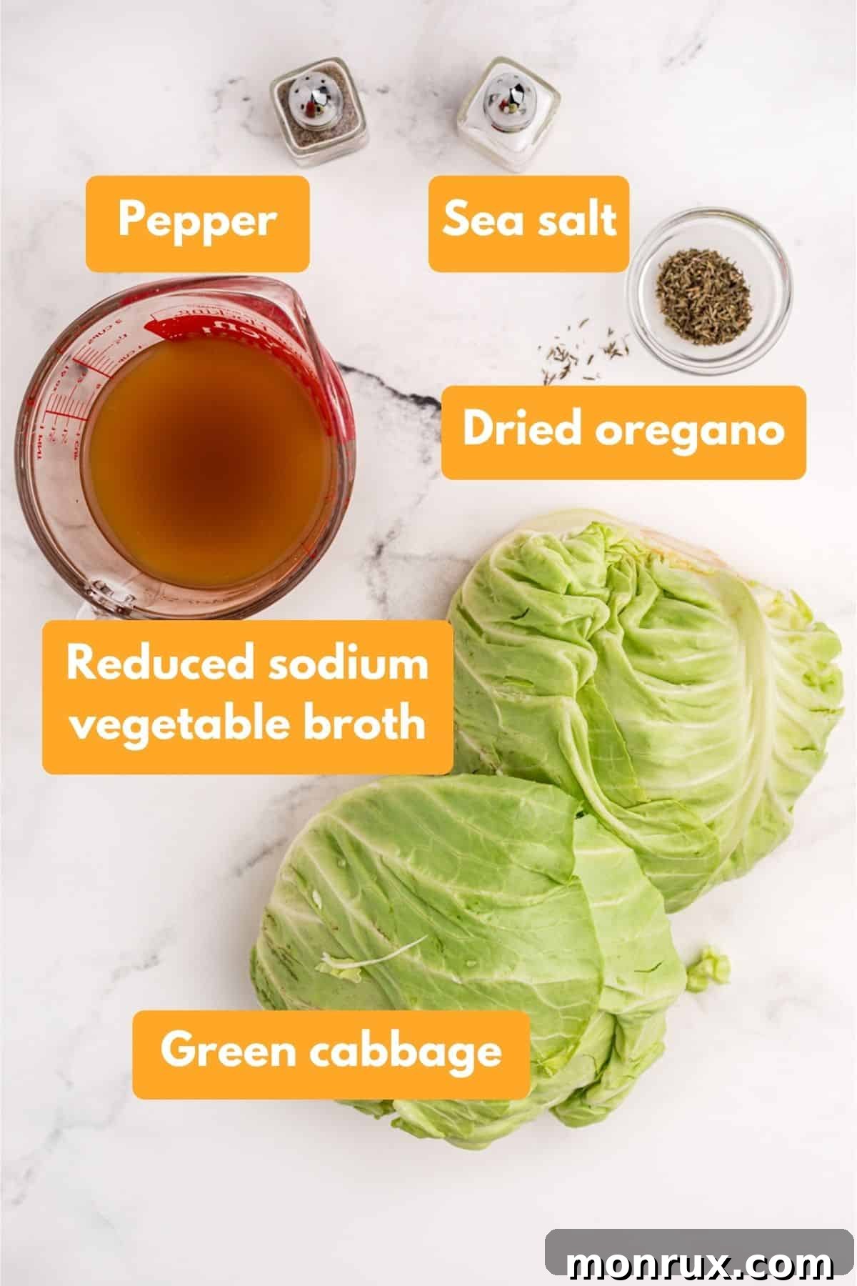 Fresh ingredients for cooked cabbage, including a whole green cabbage, broth, and a selection of dried herbs.