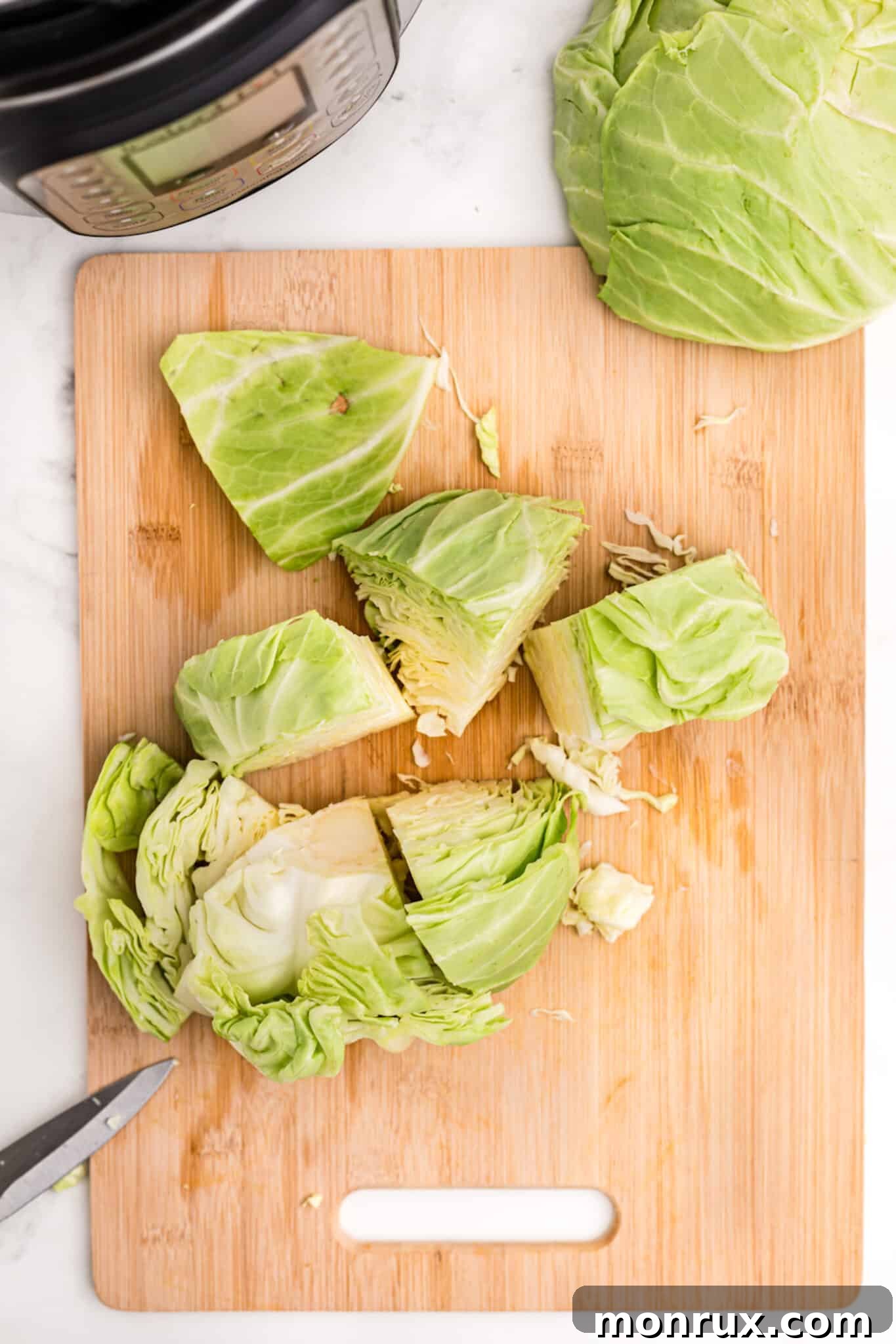 Freshly chopped cabbage on a cutting board, prepared for Instant Pot cooking.