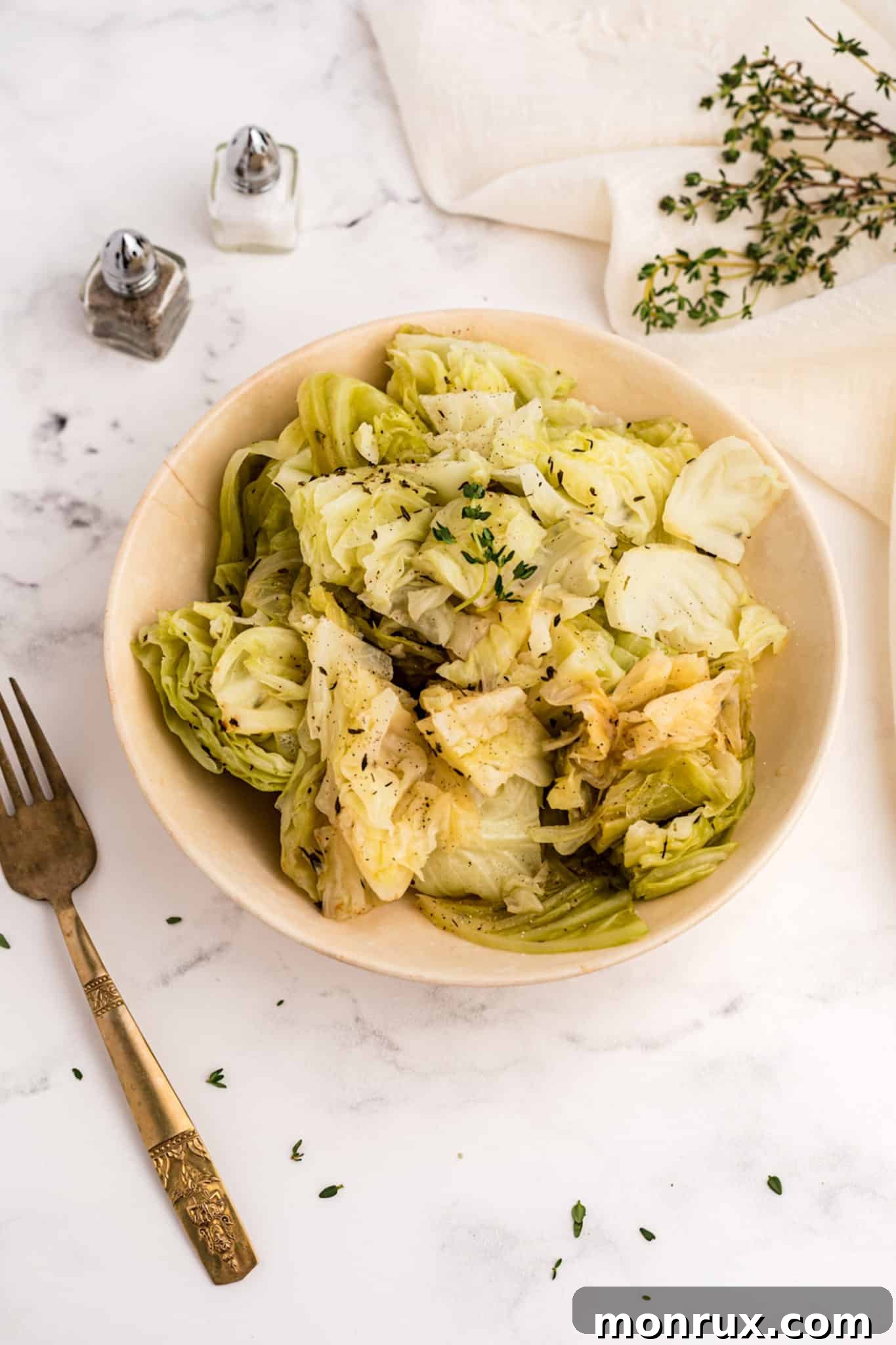 A serving bowl filled with steaming, perfectly cooked cabbage, a healthy and comforting dish from the Instant Pot.