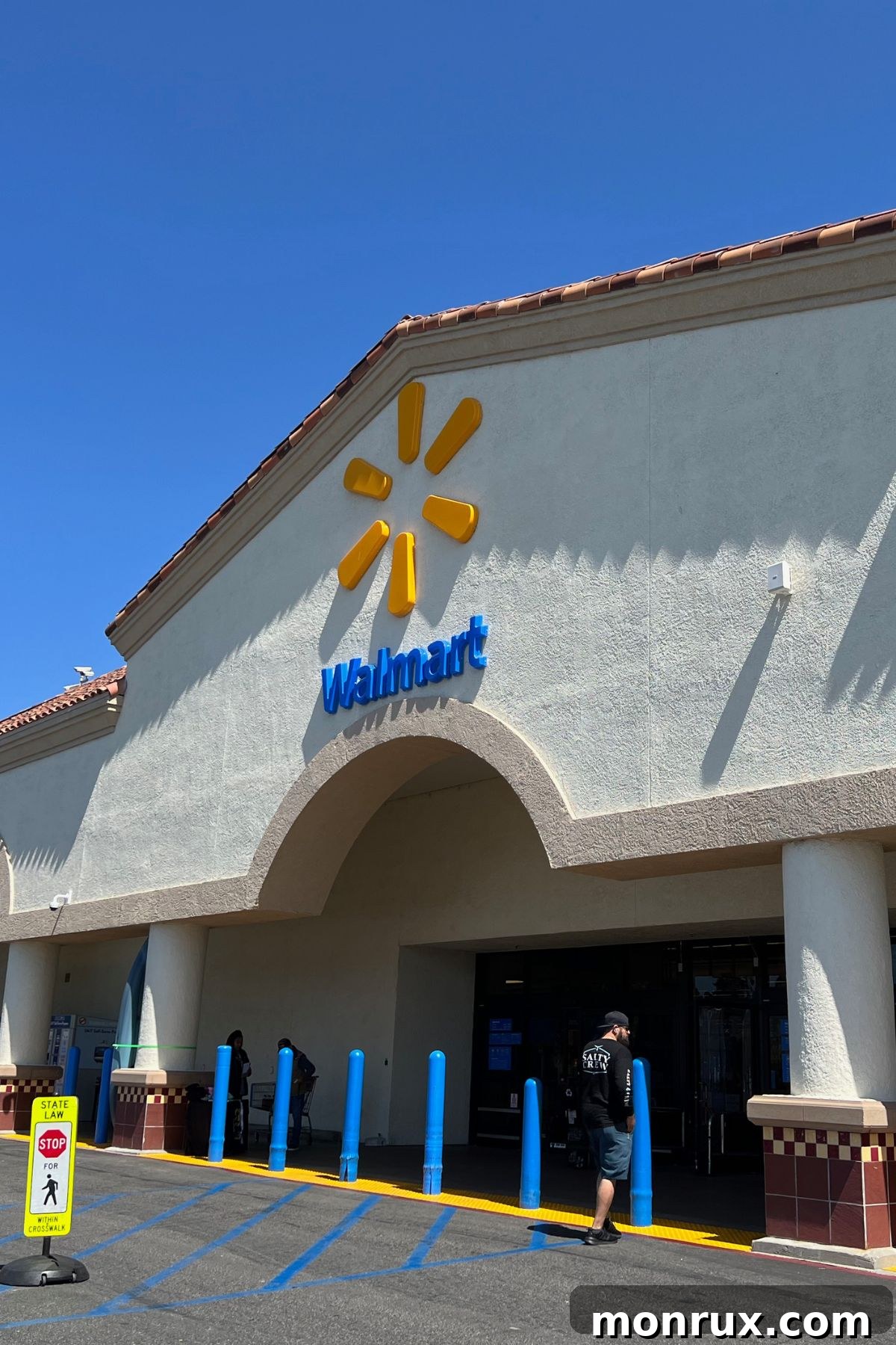 A vibrant exterior shot of a modern Walmart store, beckoning shoppers to explore its aisles.