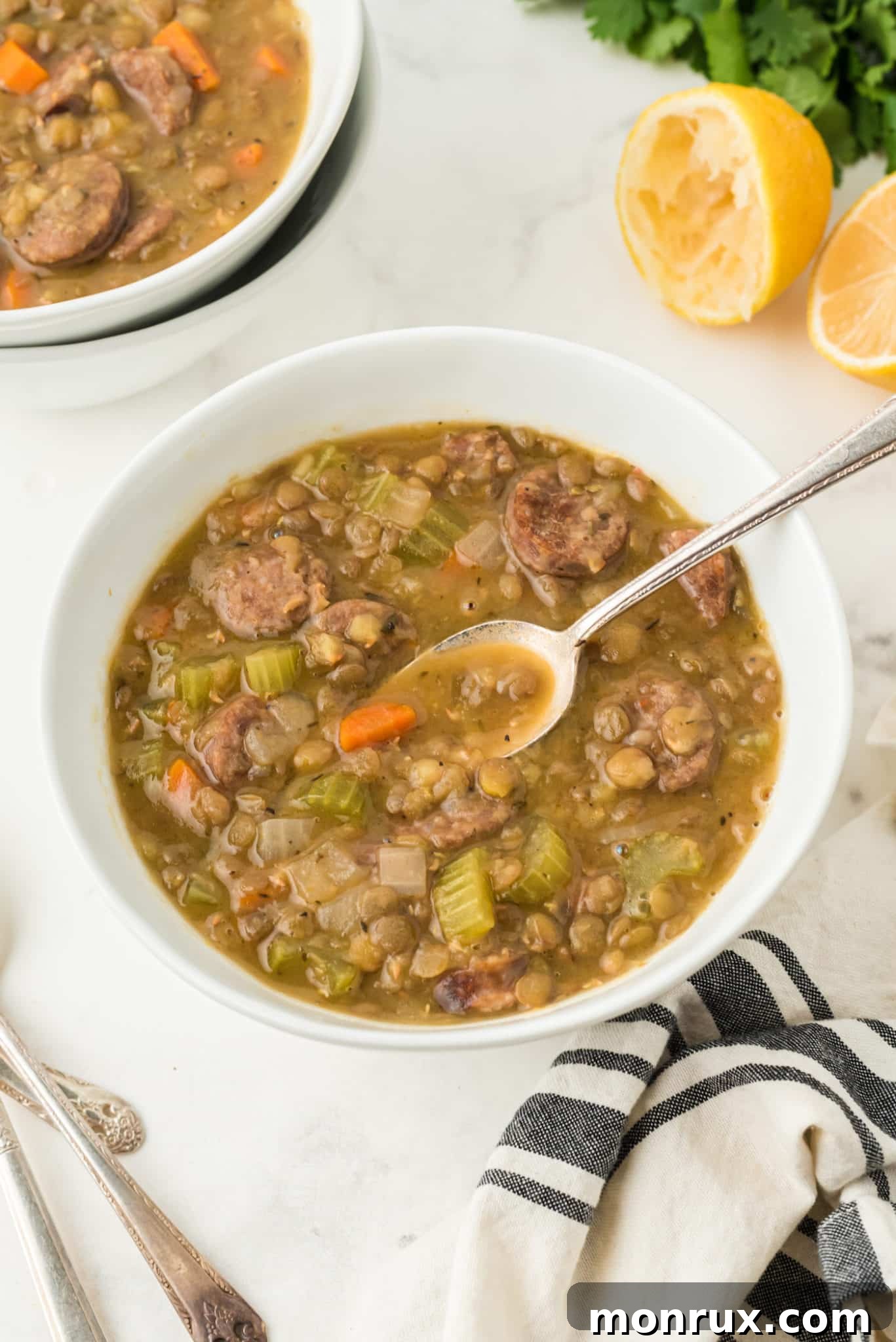 two bowls of lentil soup on a table.