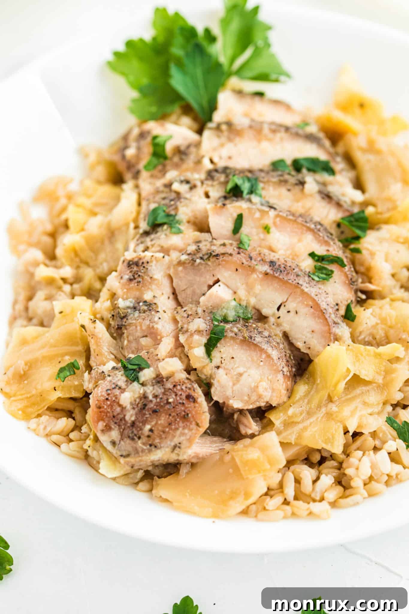 A beautiful plate featuring keto chicken thighs cooked in a crockpot, accompanied by tender cabbage and fluffy cauliflower rice, ready to be enjoyed.