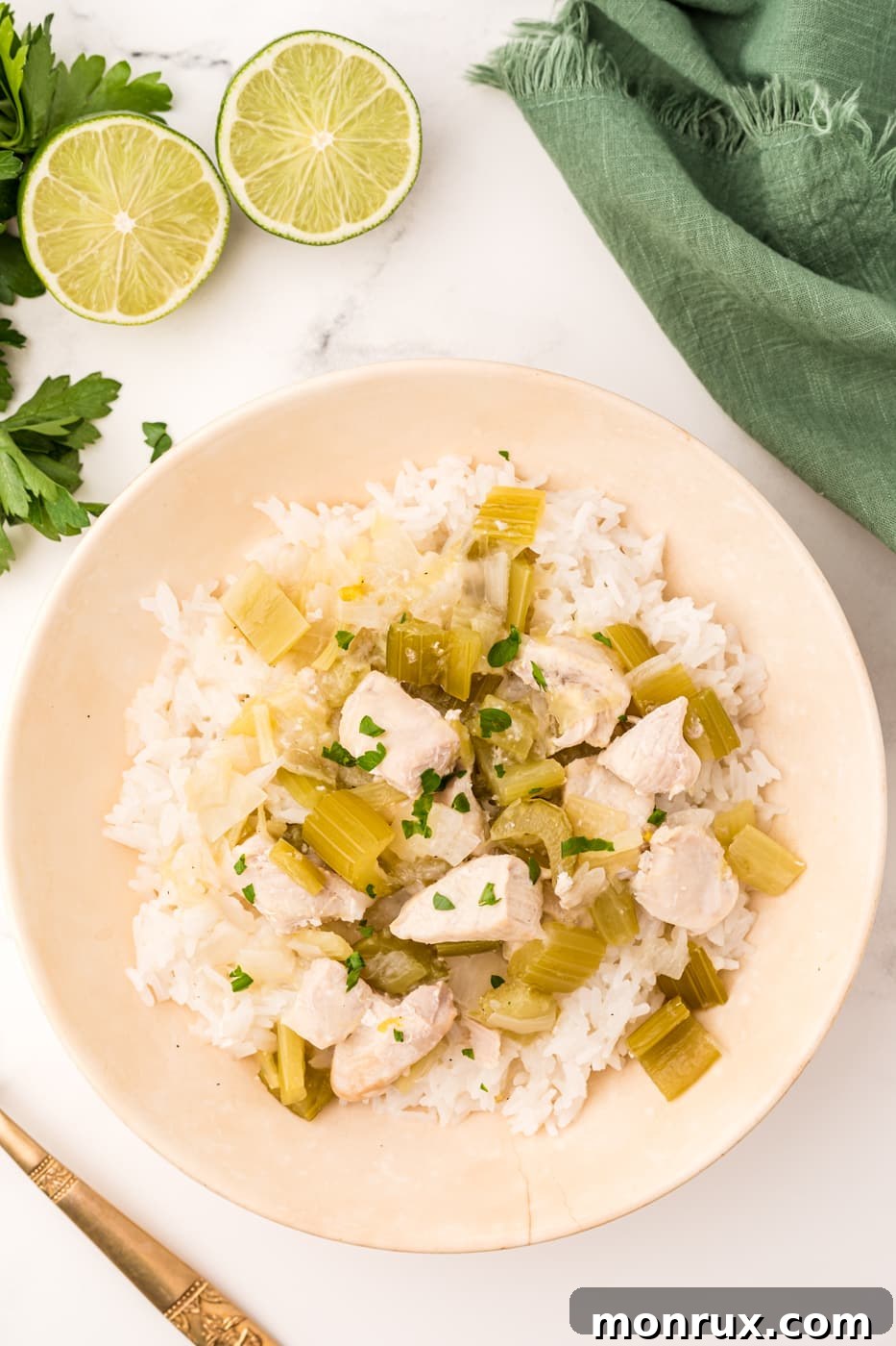 Instant Pot coconut chicken with rice served in a bowl, garnished with fresh lime and cilantro.